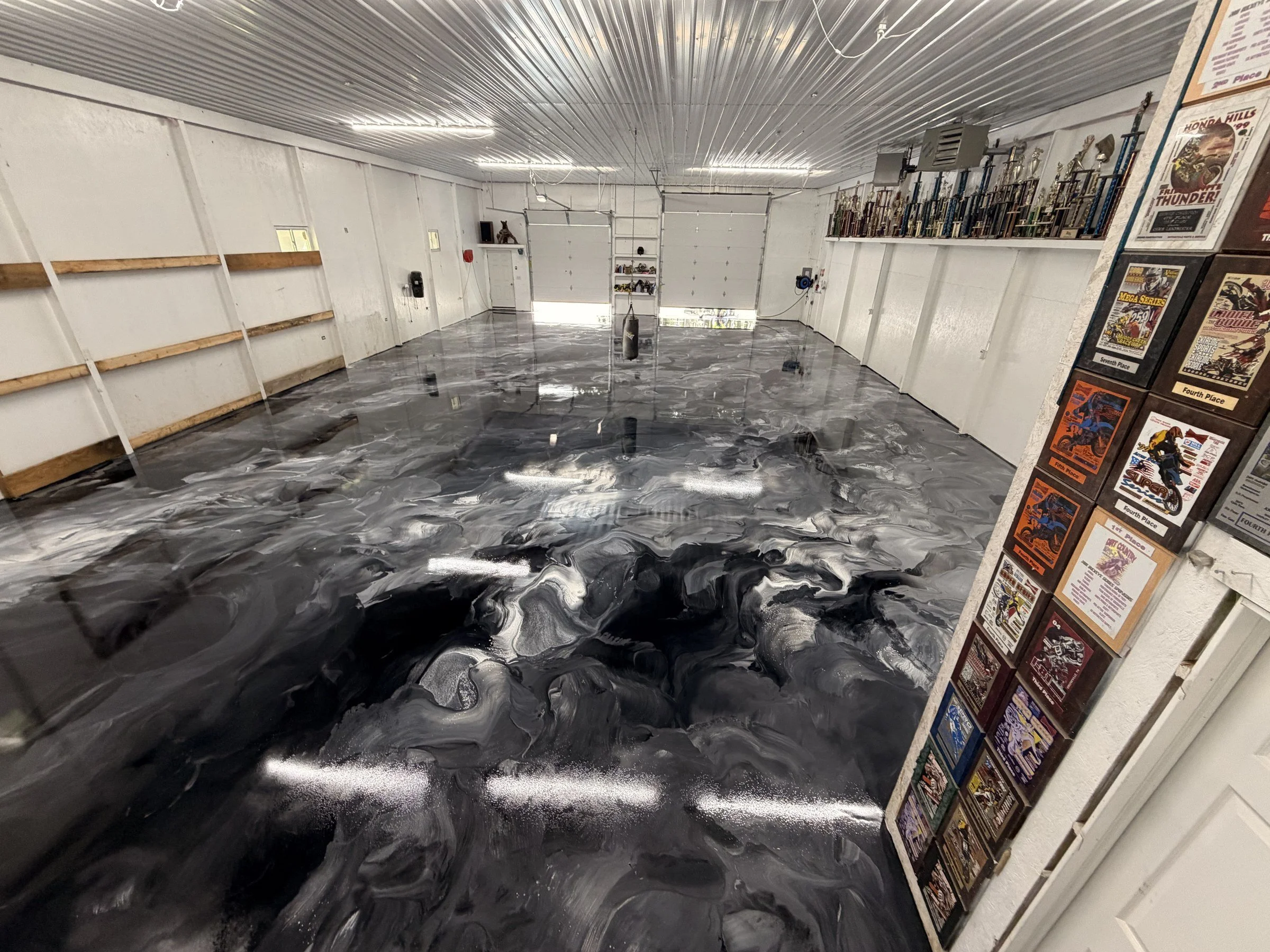 Silver and black metallic epoxy floor in a pole barn shop by J&G Epoxy Coatings