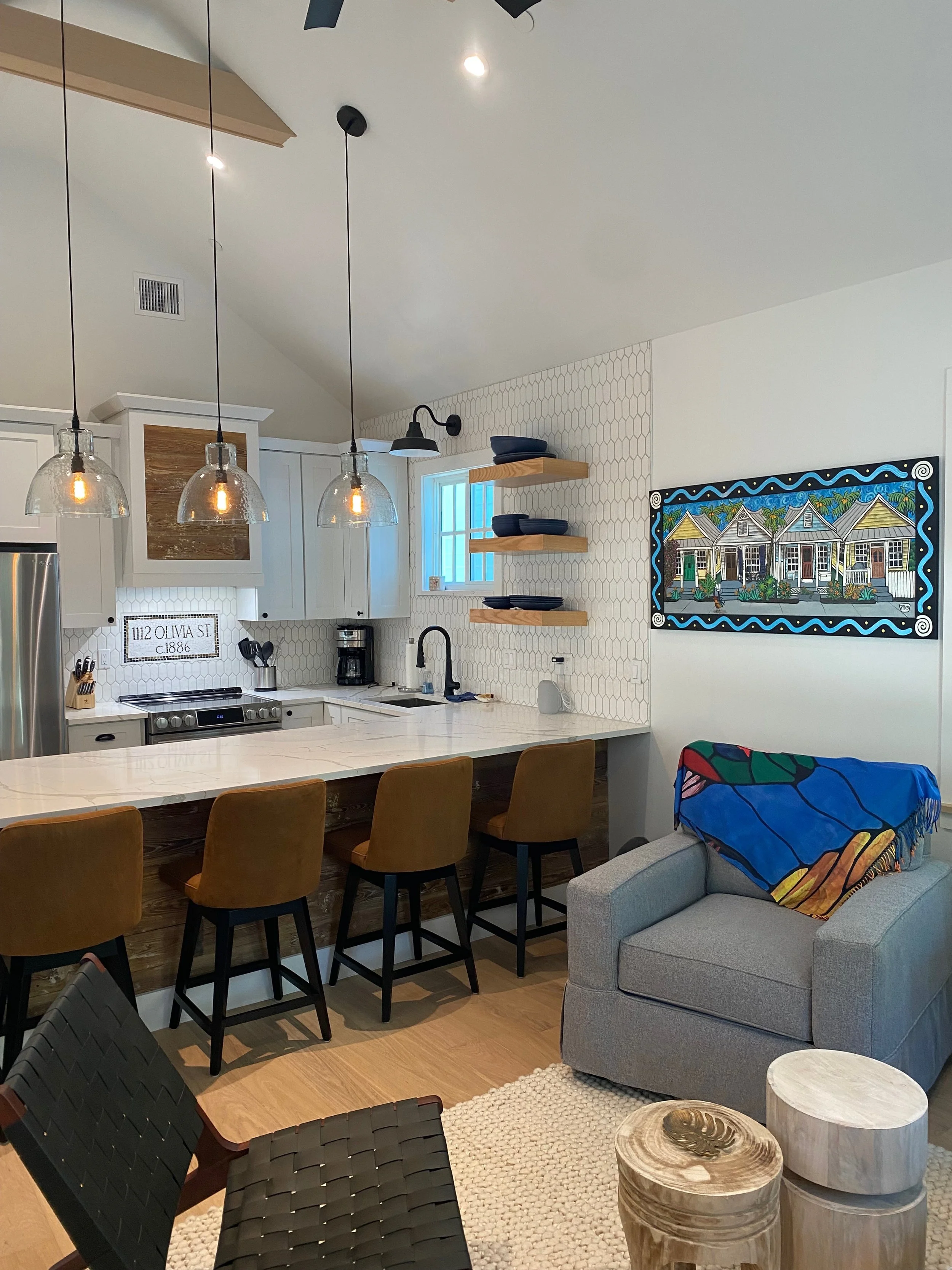 Custom artwork of the neighborhood cigar rollers cottages and a custom backsplash with the original construction date bring history and modern construction together 
