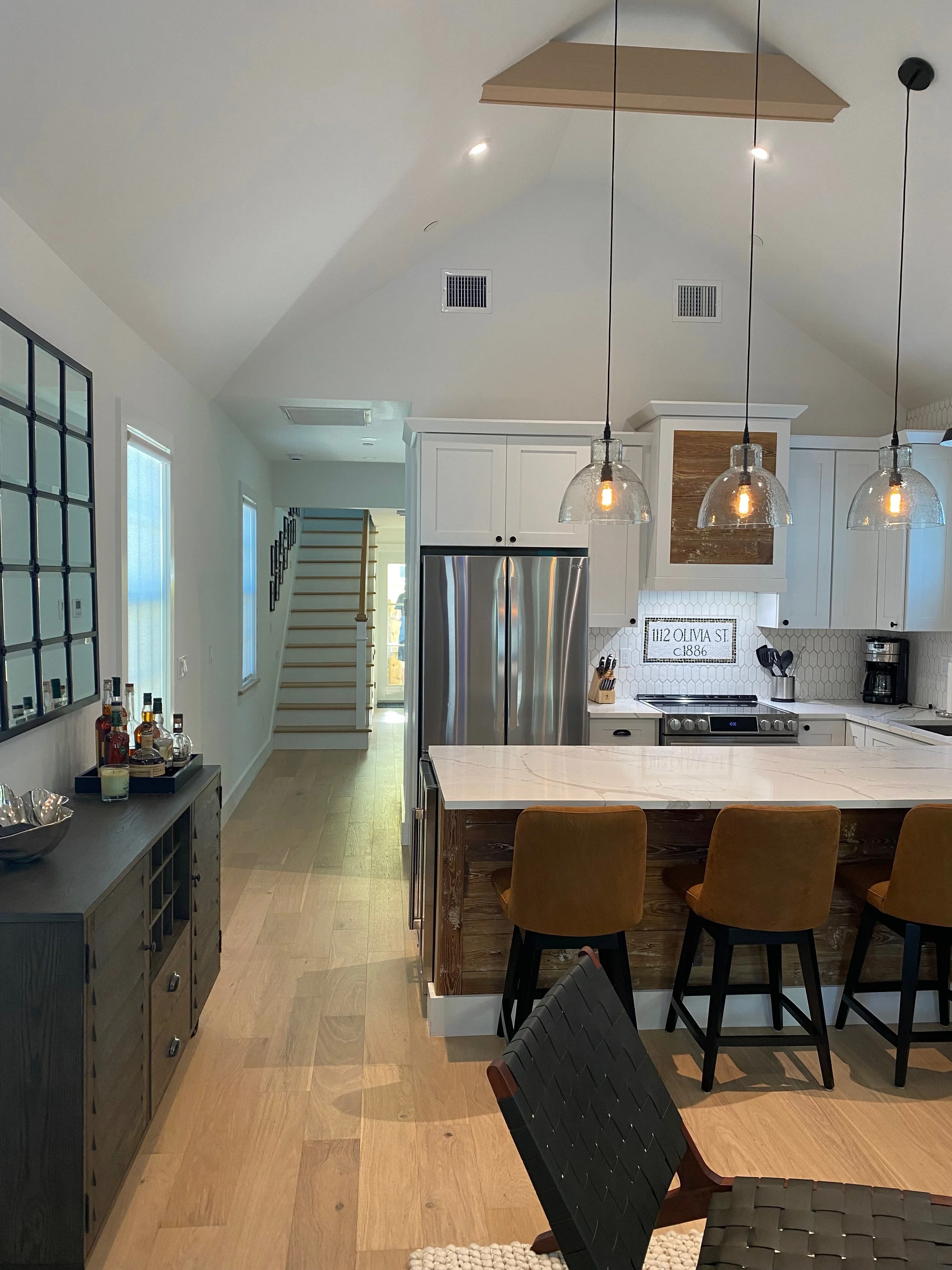 Living, dining, and kitchen with vaulted ceilings