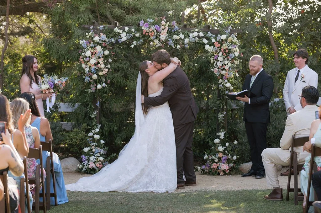 Red Horse Barn wedding Ceremony. Bride and Groom first kiss