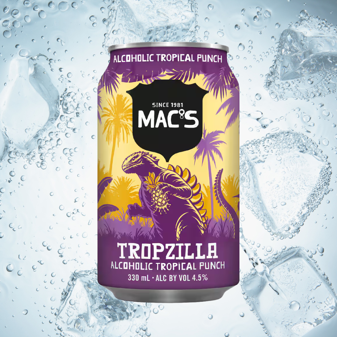 A can of MAC'S Tropzilla alcoholic tropical punch flavored beverage with a purple and yellow design featuring a lizard and palm trees, set against a background of ice cubes and splashing water.