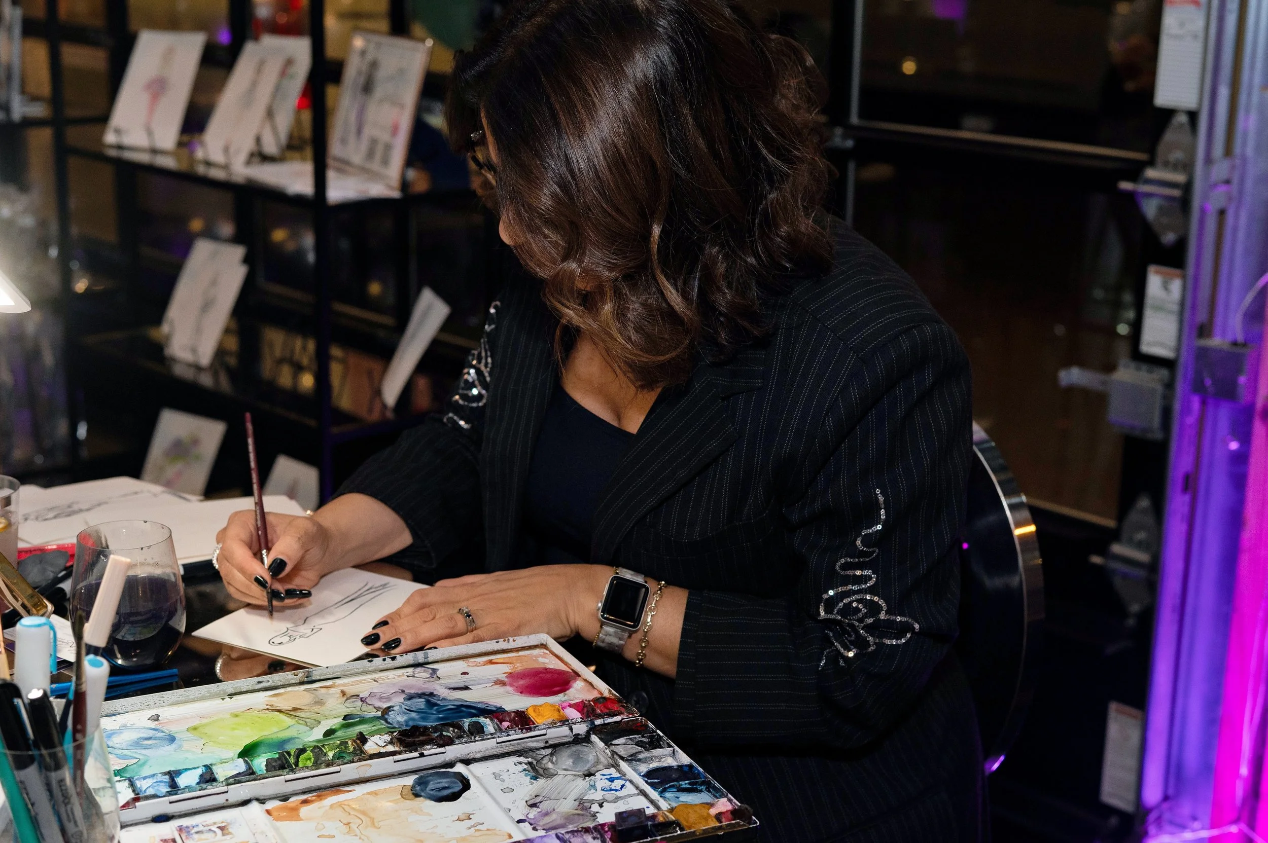 artist painting a guests portrait at a silver soiree event