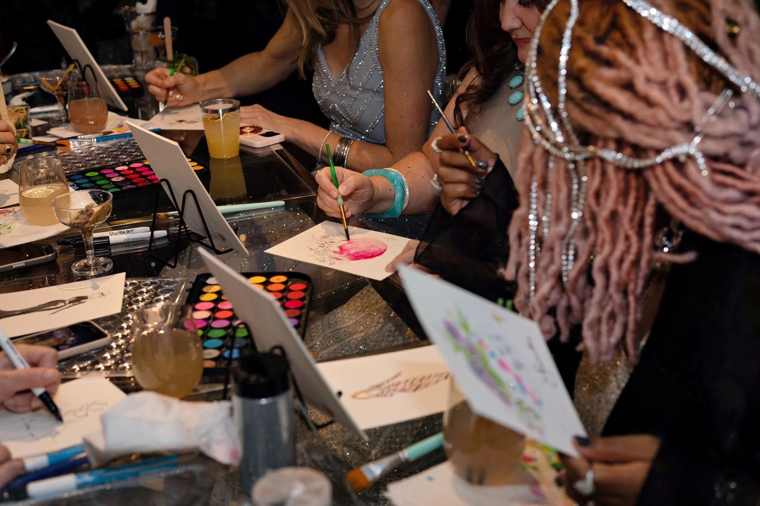 Zoomed in picture of guests painting their own pictures during a guided art experience