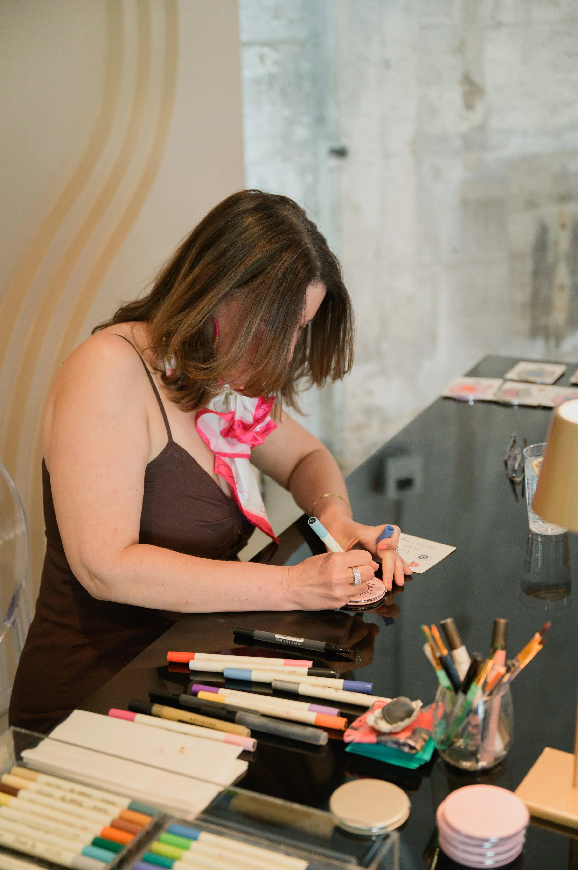 Artist painting on mirror compacts live