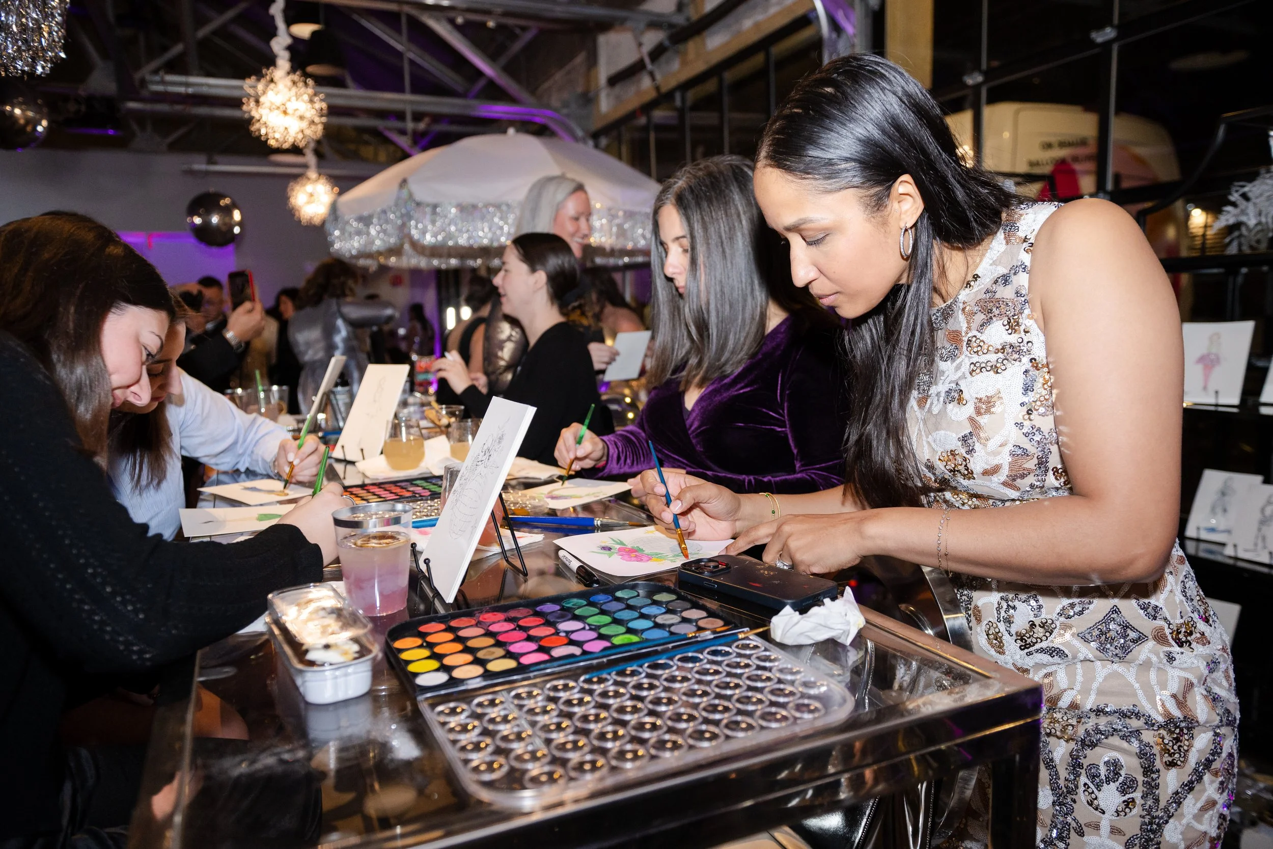 Guests painting their own pictures at a corporate soiree