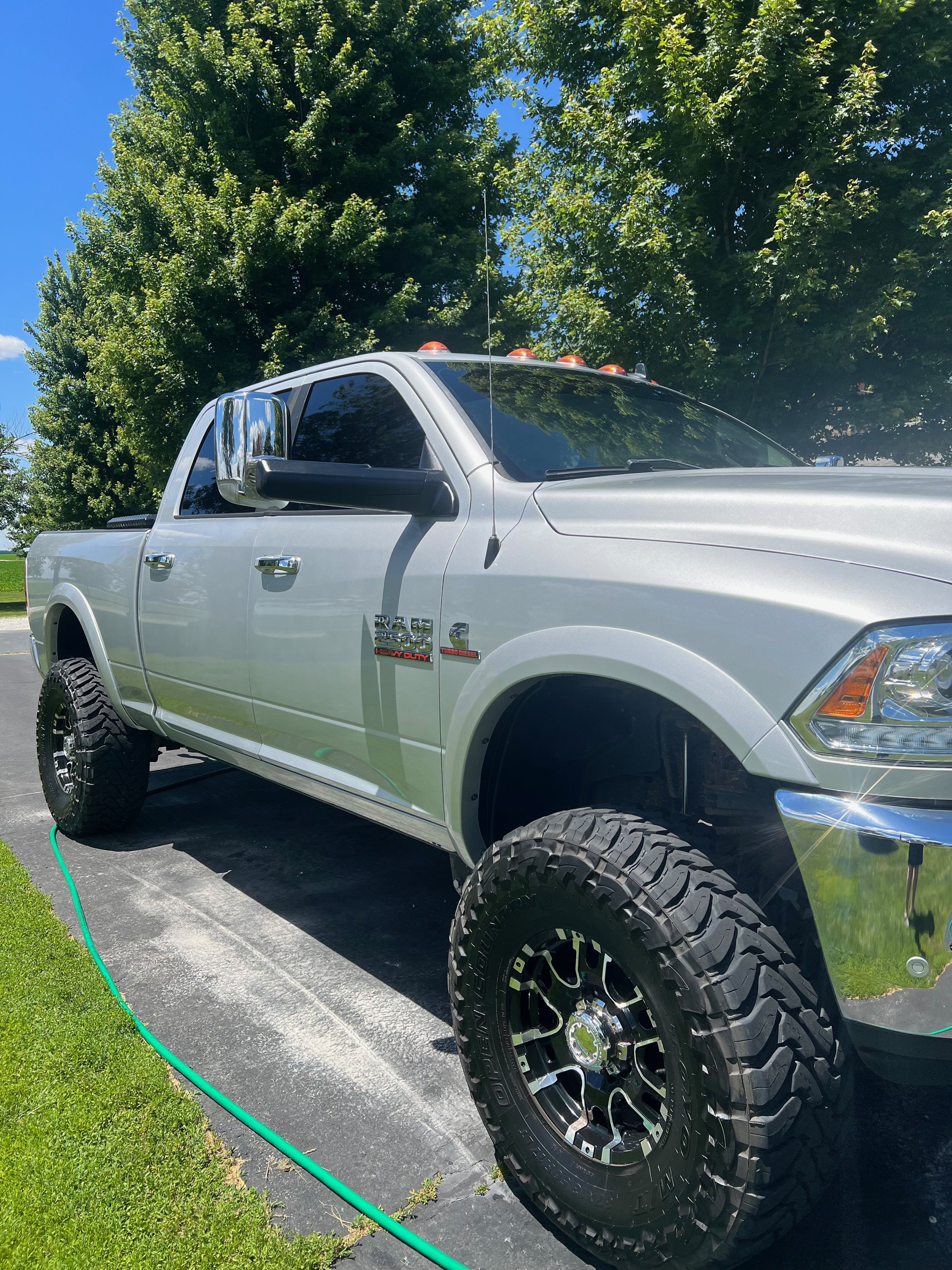 Close-up of wheel and tire detailing, showing brake dust removal and tire shine application.