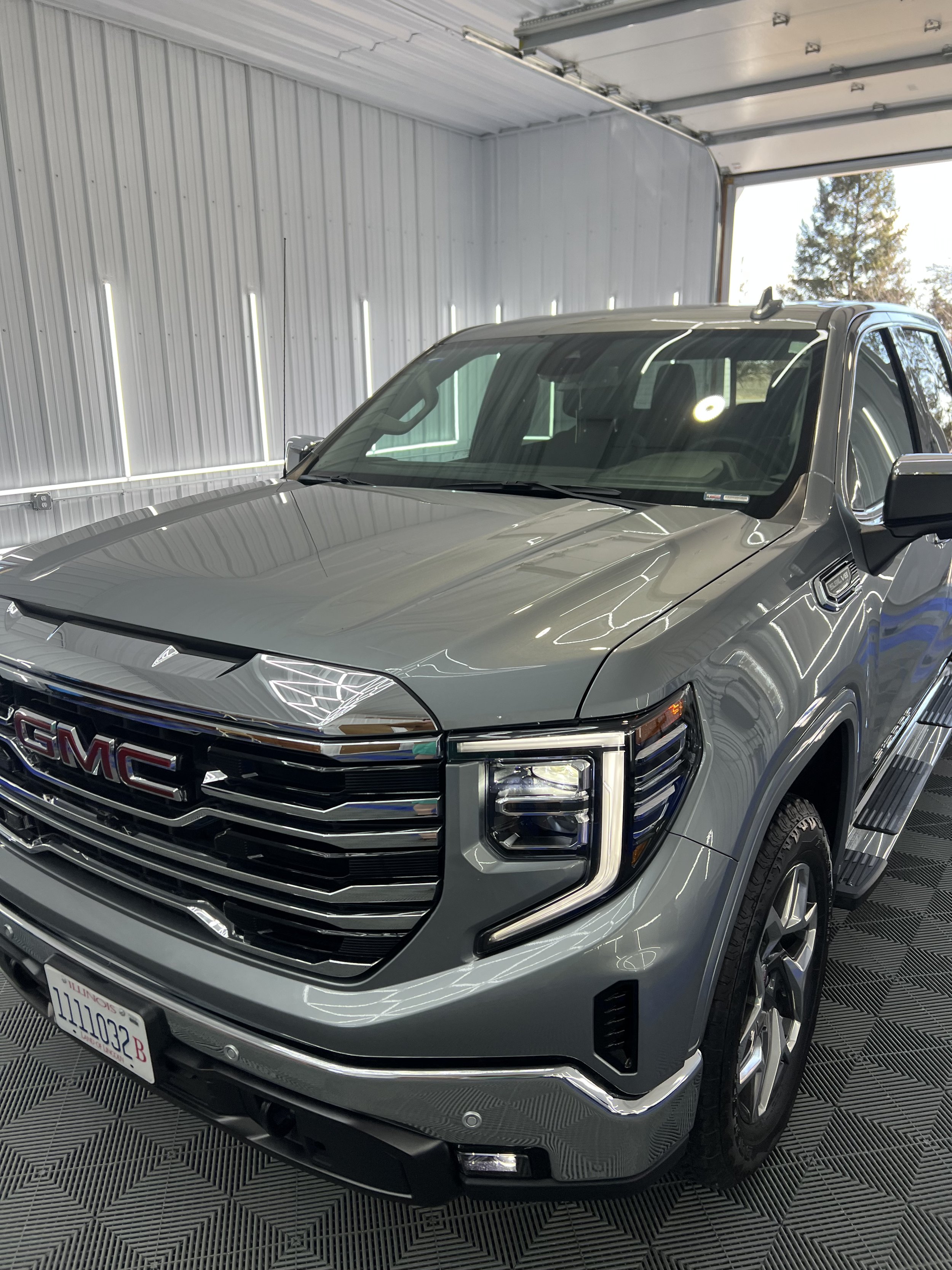 Application of ceramic coating on a vehicle's hood, providing long-lasting paint protection.