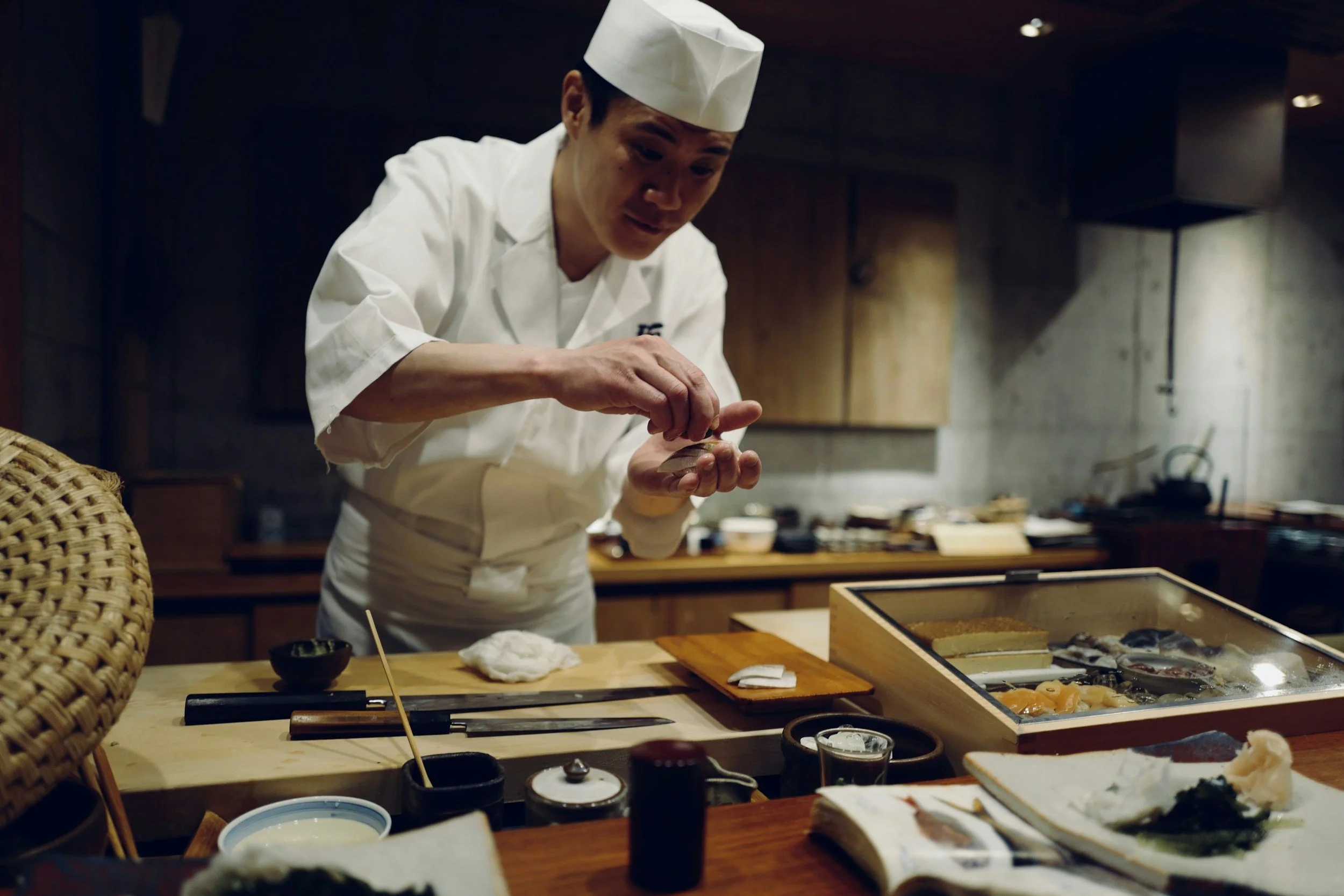 chef in a kitchen preparing sushi