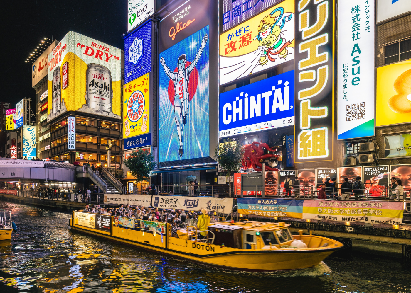 bright, LED sign boards by river with a boat