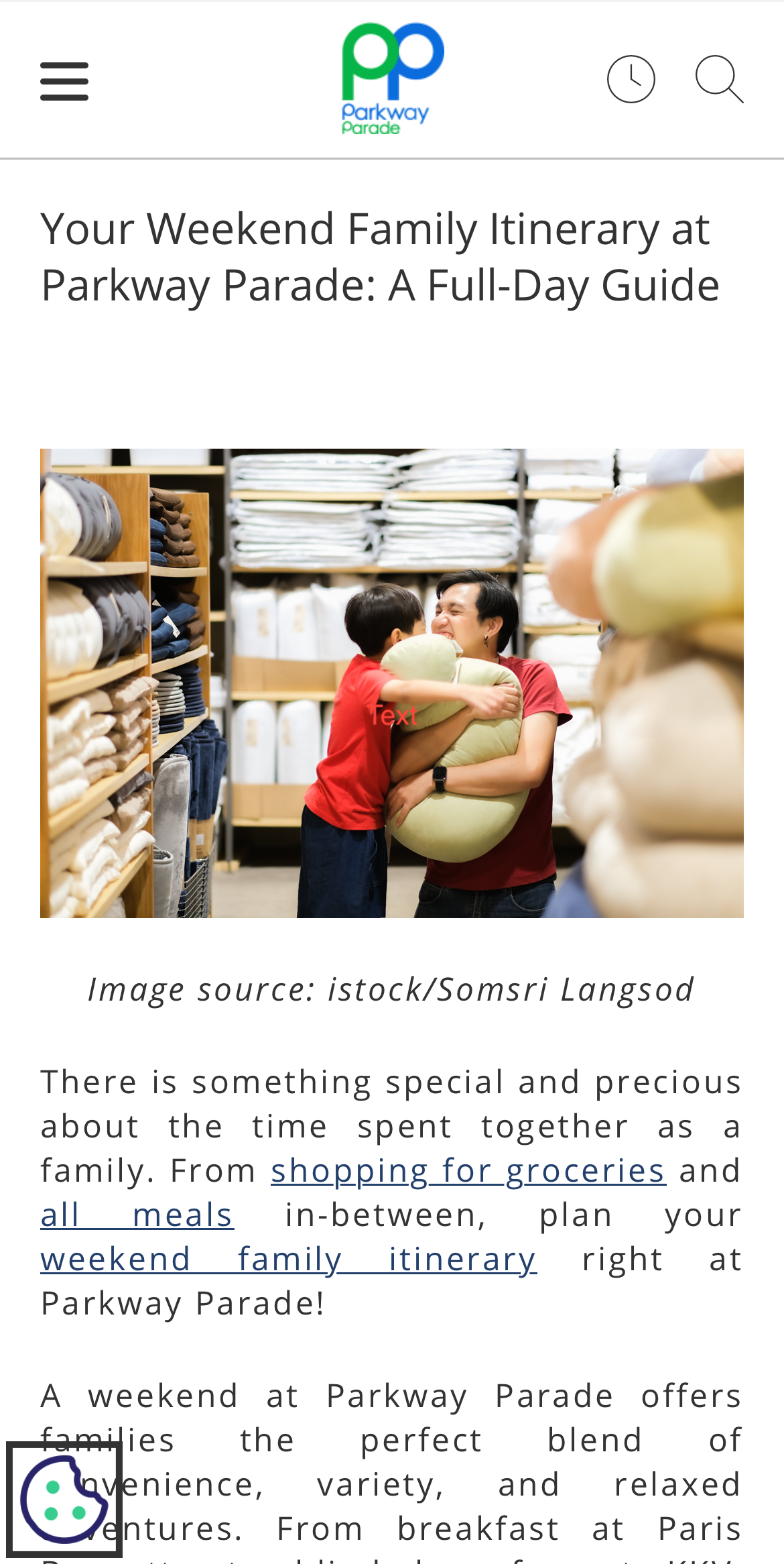 A woman and a boy in a store, hugging. Shelves of pillows and bedding in the background.