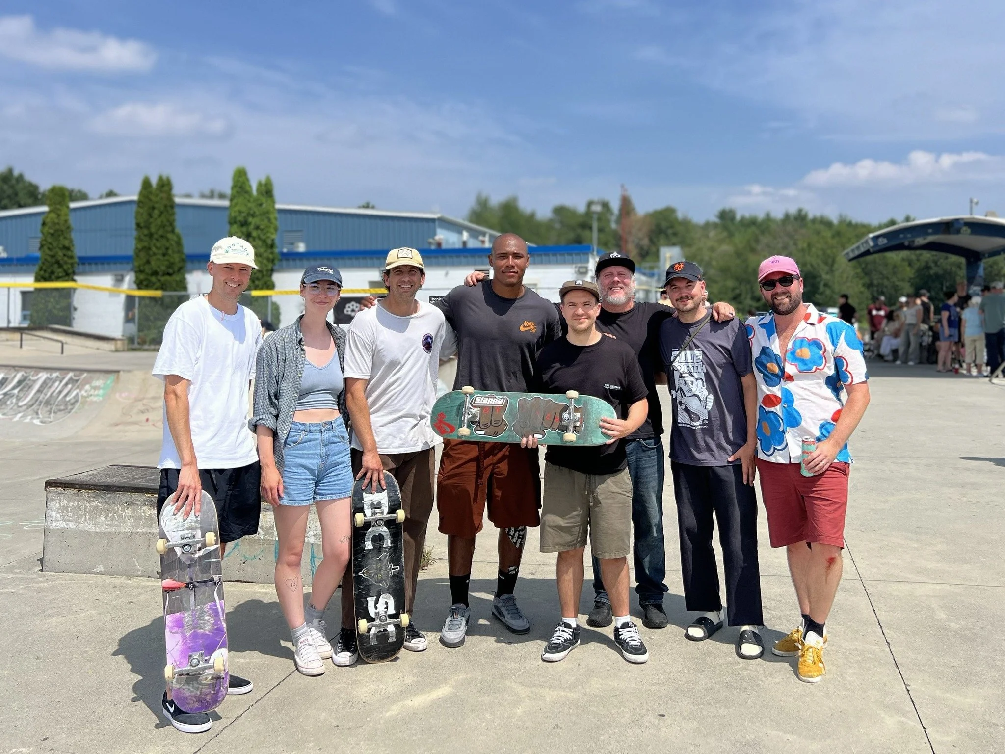 Directors from Ollie North stand for a photo with professional skateboarder Cordano Russell. Photo by Amir Hossein.