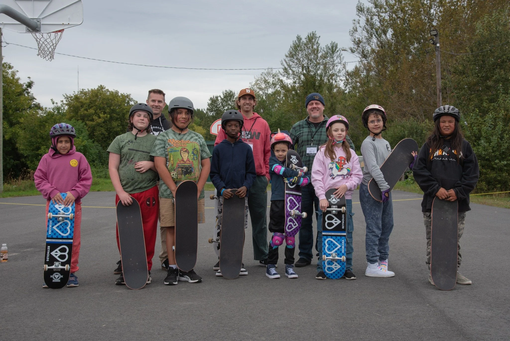 Ollie North Directors Brian Joblin, Jeff Bona and Phil Laframboise pose for a photo with youth during a free Learn to Skate session.