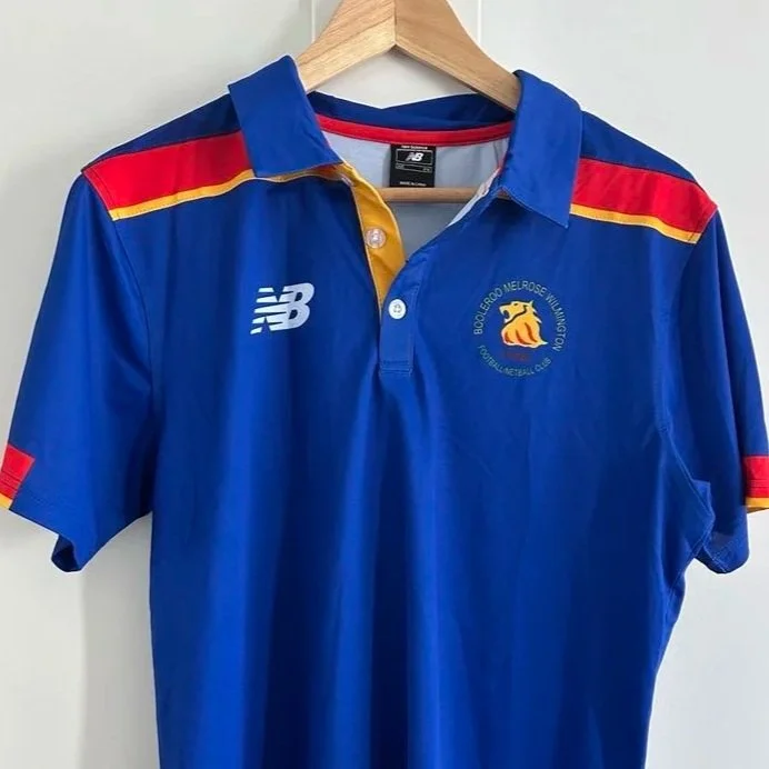 man holding a child with a footbal