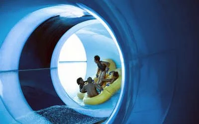 family-riding-down-tube-slide.jpeg