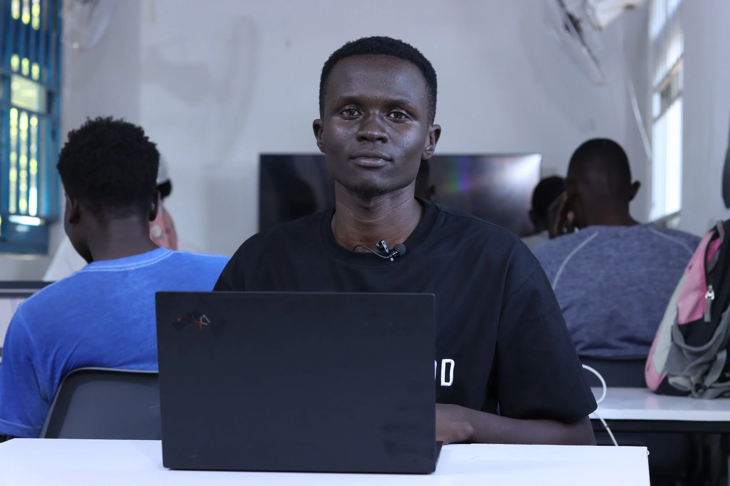 3D modelling student in Kakuma Refugee Camp working on a laptop at the Creative Gateway container hub during a digital skills training session for remote freelance work