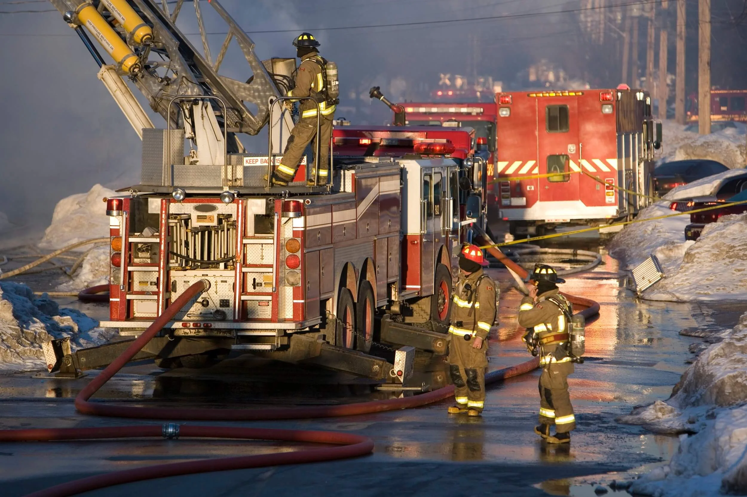 several firefighters around a firetruck responding to an emergency