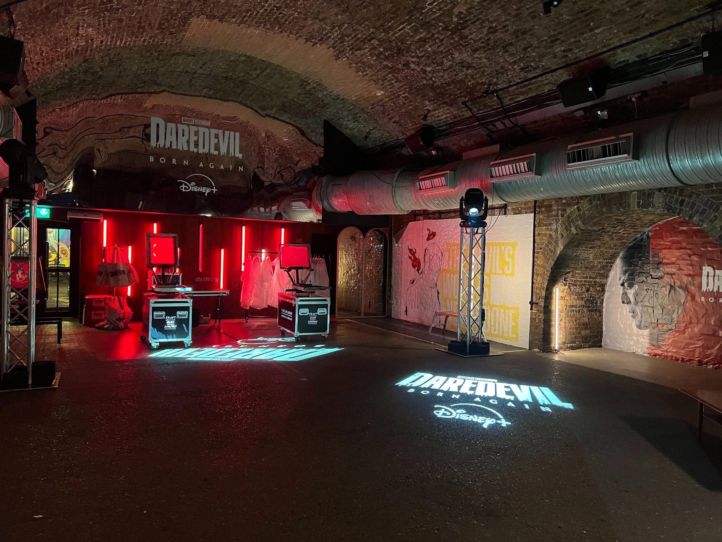 Daredevil: Born Again activation with projected logo in a railway arch