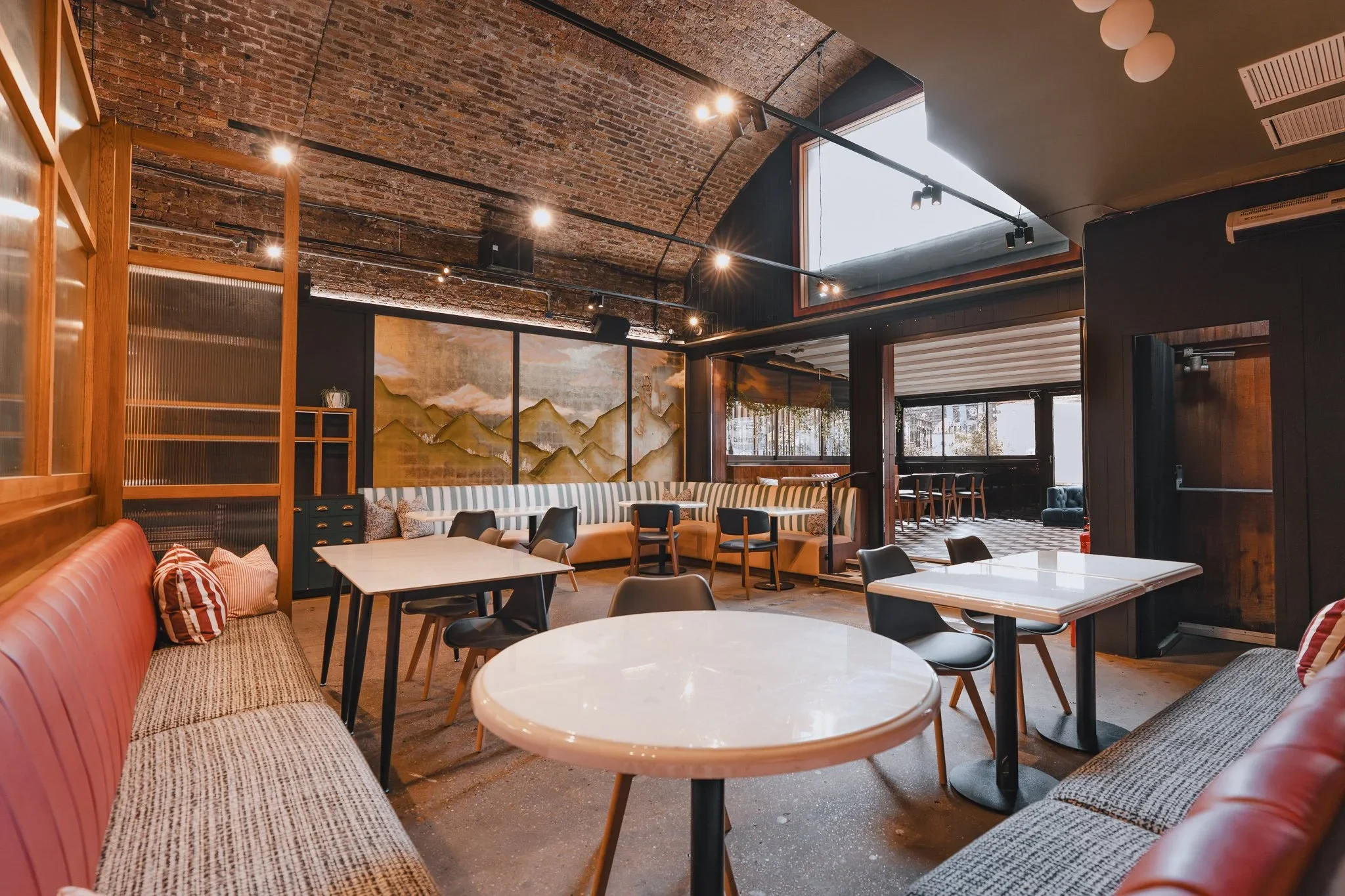 Arch 1 restaurant dining tables under a vaulted brick ceiling, Shoreditch
