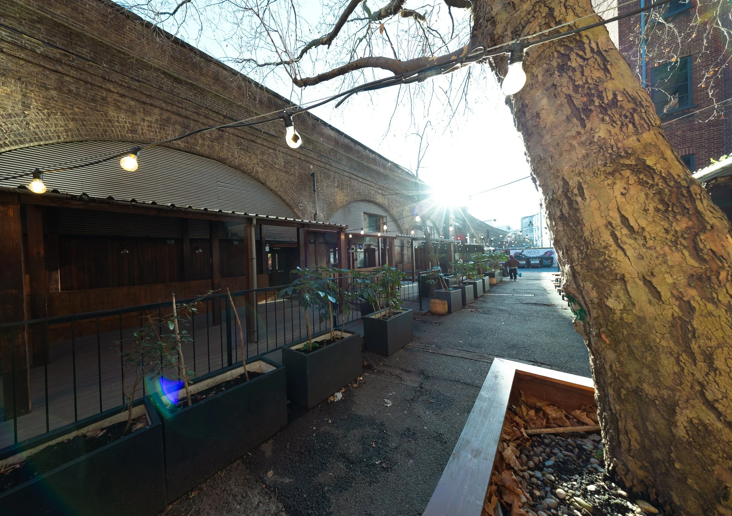 Outdoor terrace along the railway arches with festoon lights, Shoreditch
