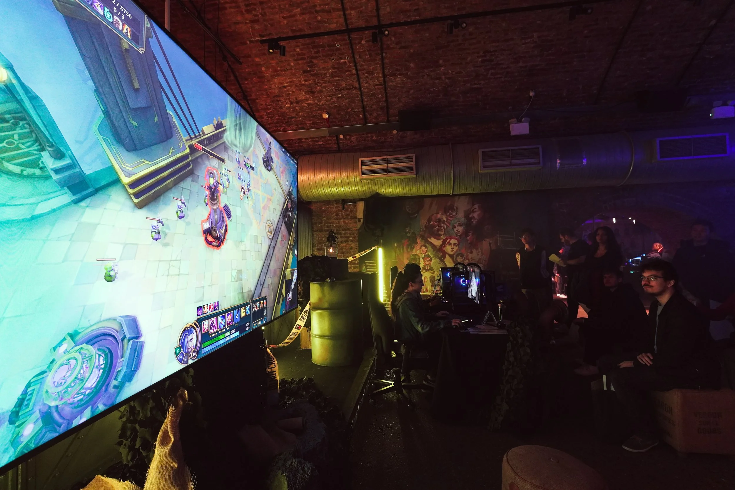 Gaming tournament with a large screen and audience in a railway arch venue