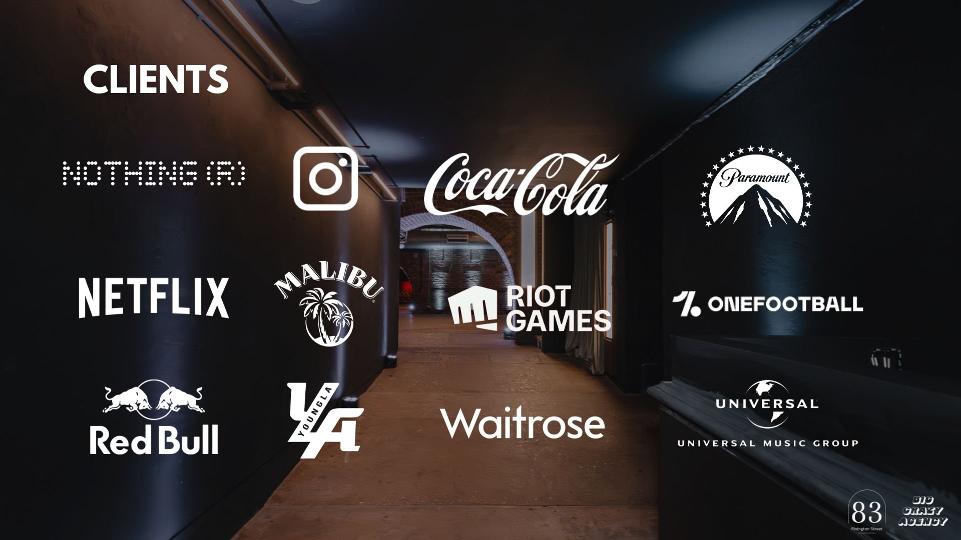 Dark hallway with various company logos overlaid, including Coca-Cola, Netflix, Red Bull, Malibu, Riot Games, Universal, Waitrose, OneFootball, and others.