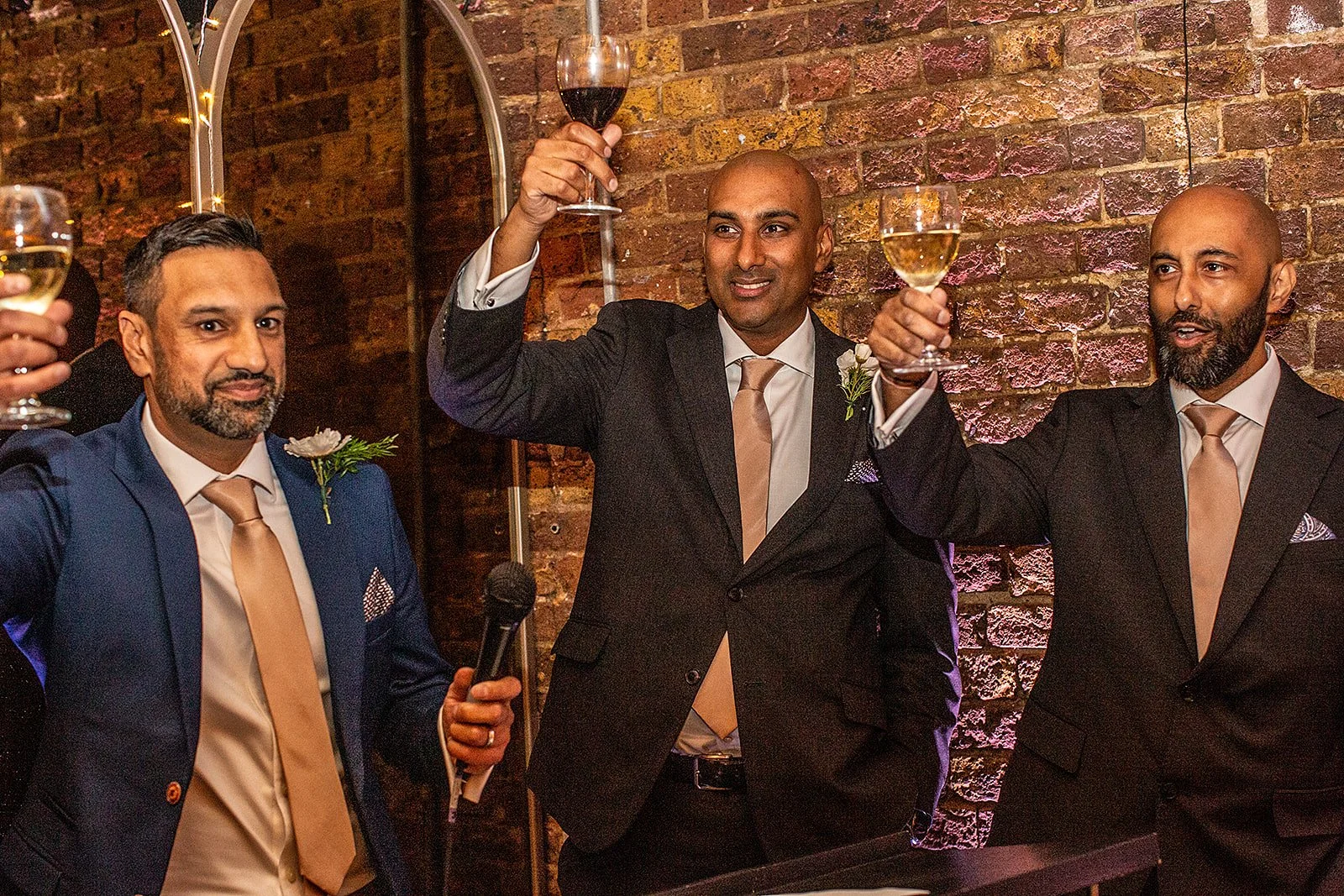 Groom and guests raising a toast at a wedding celebration