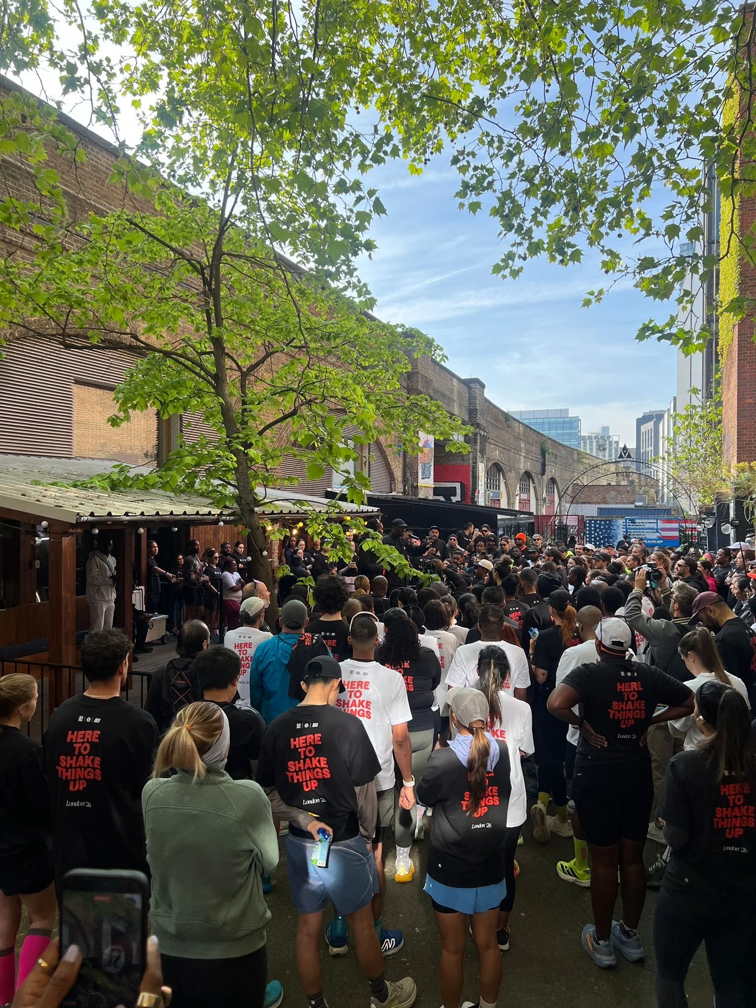 lululemon at 83 rivington street, a sea of people listening to someone talk in a venue courtyard