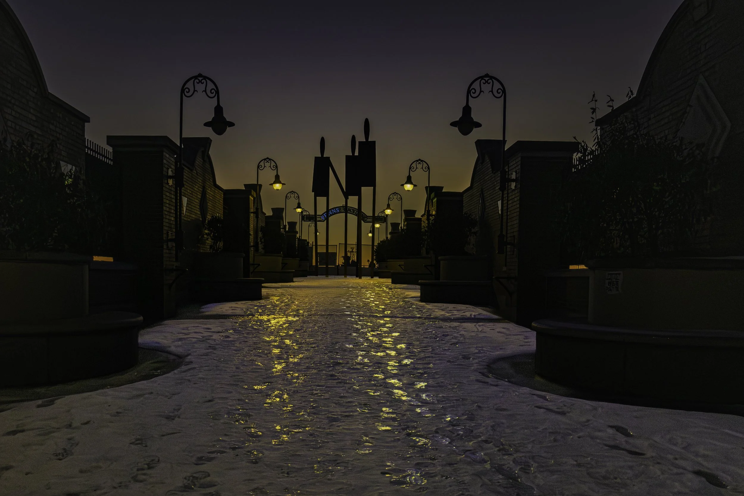 Reflections on the Bridge
Snow-covered South Street Bridge over Delaware Avenue with glowing lampposts and reflected light along the walkway at blue hour.