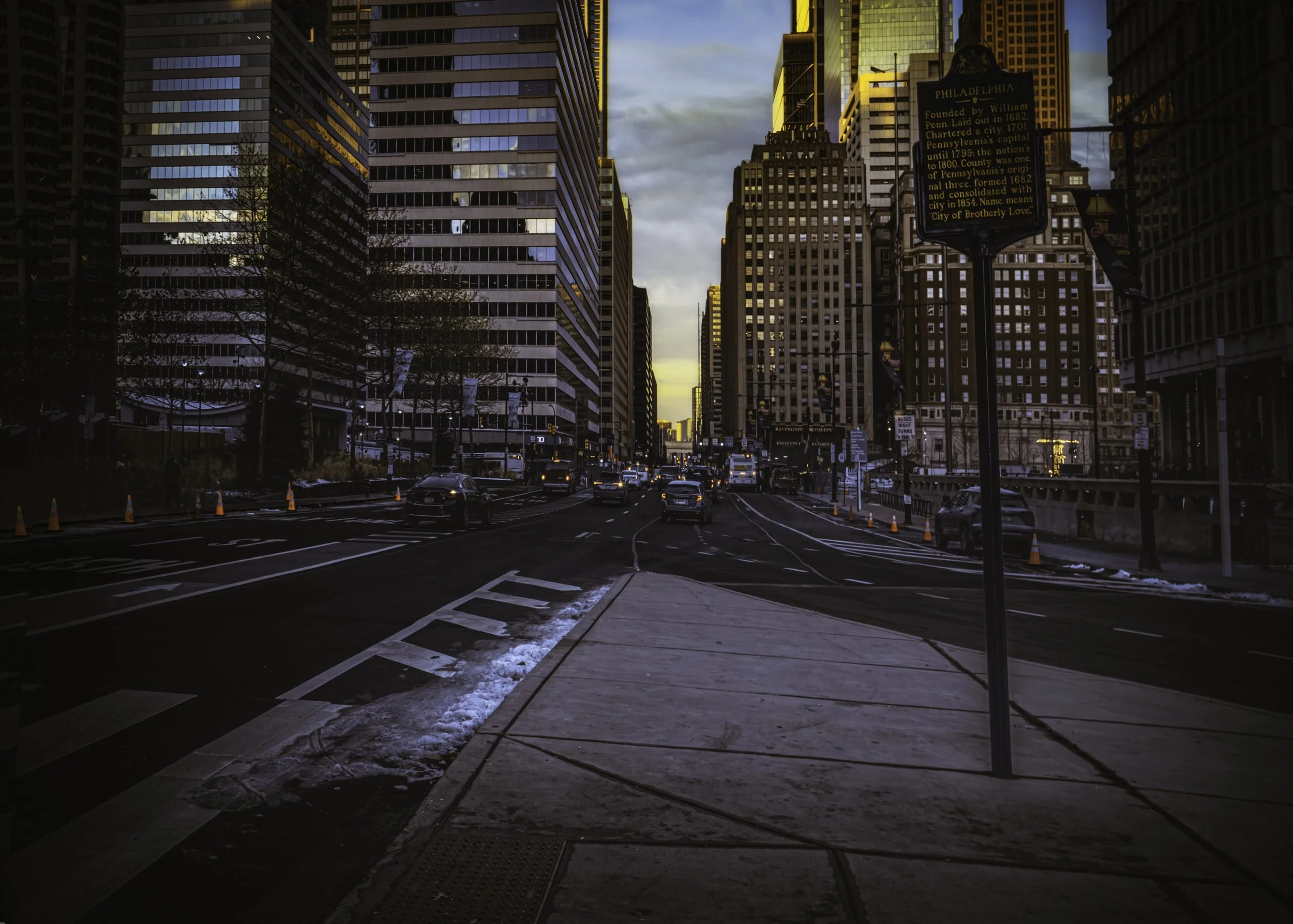 Winter Street at Dawn
Downtown Philadelphia street with winter snow, traffic, and high-rise buildings at dawn.