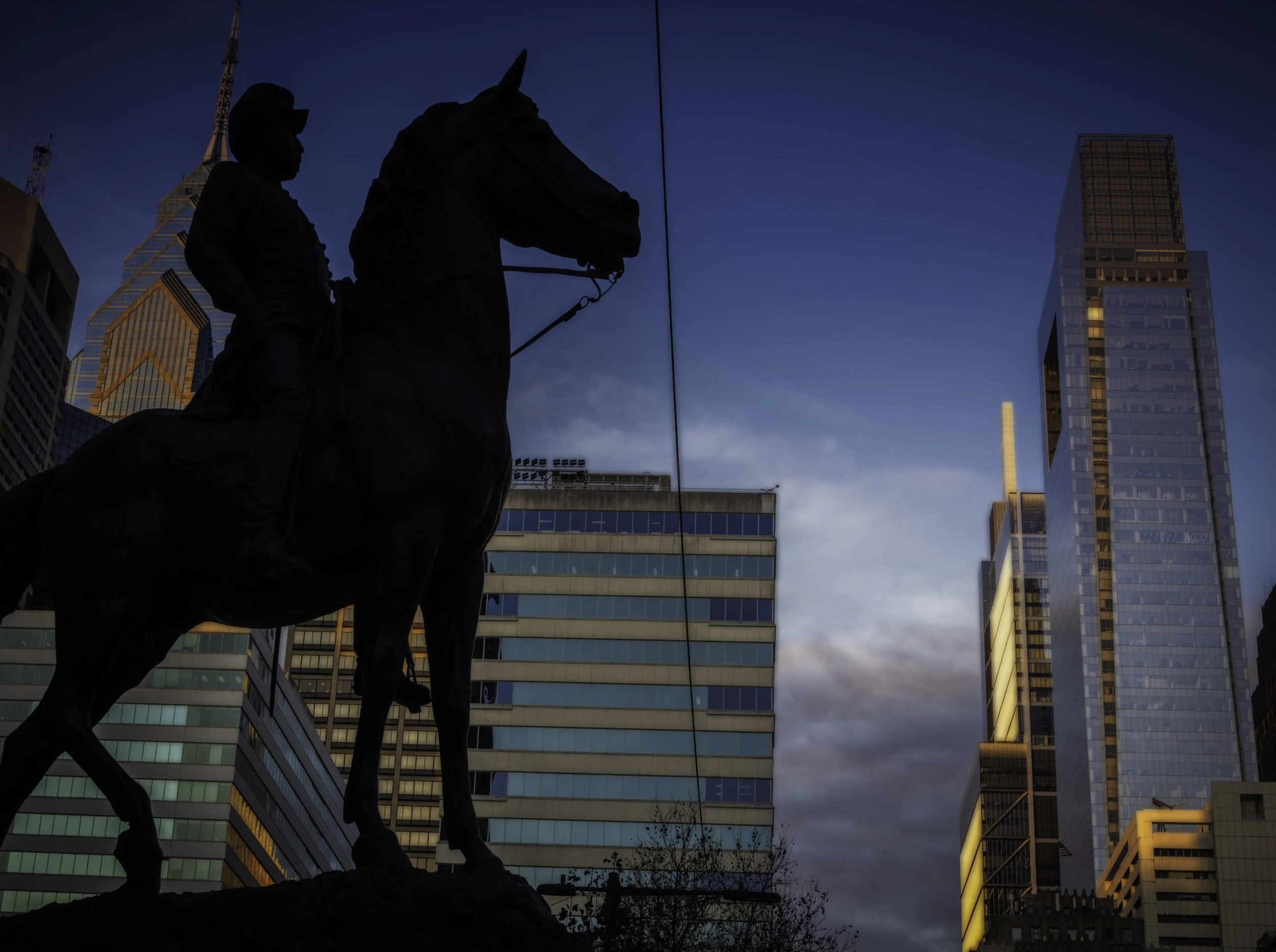 City Hall North Side
Equestrian statue silhouetted against the Philadelphia skyline and glass office towers at blue hour.