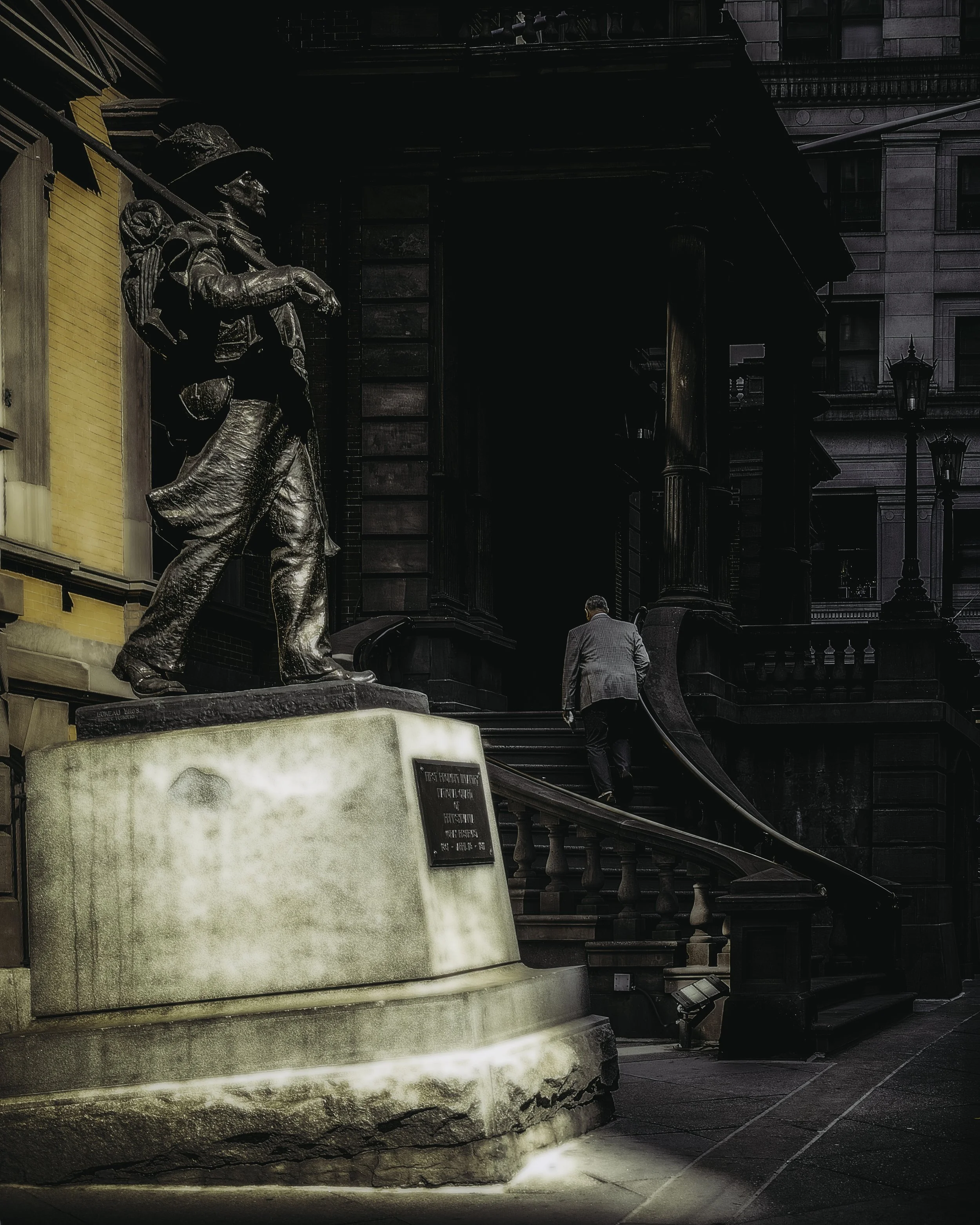 Ascending the League
The Union League of Philadelphia entrance with a bronze statue in the foreground and a man climbing the steps.