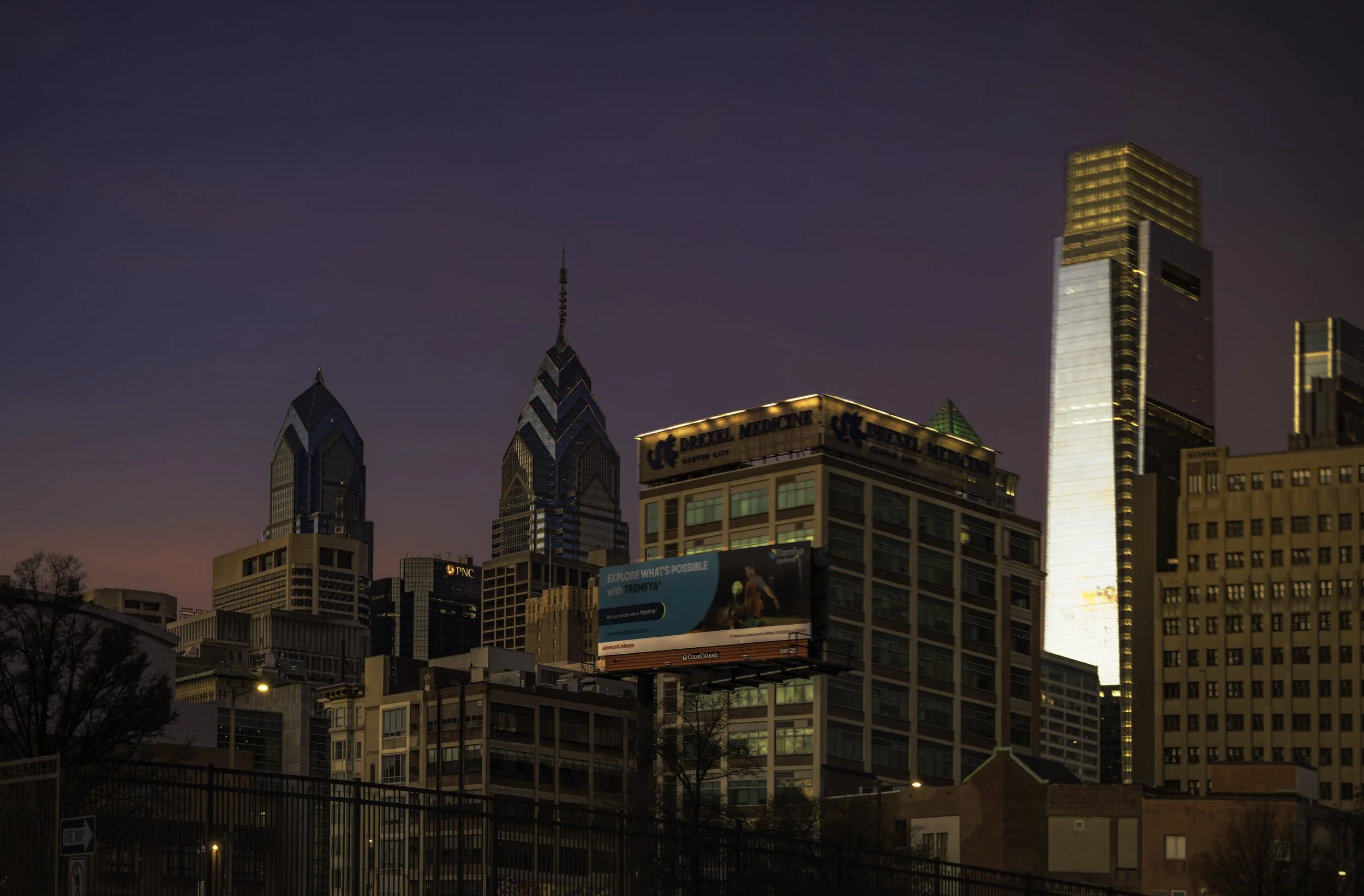 Skyline Before Sunrise.
Philadelphia skyline and billboard beneath a purple early morning sky before sunrise.
