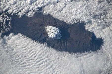 The Roof of Africa &mdash; seen from space 🏔️✨
Even from hundreds of kilometers above Earth, Mount Kilimanjaro (5,895 m / 19,341 ft) rises proudly through the clouds A snow-capped icon standing alone on the vast African plains.

A reminder that ever