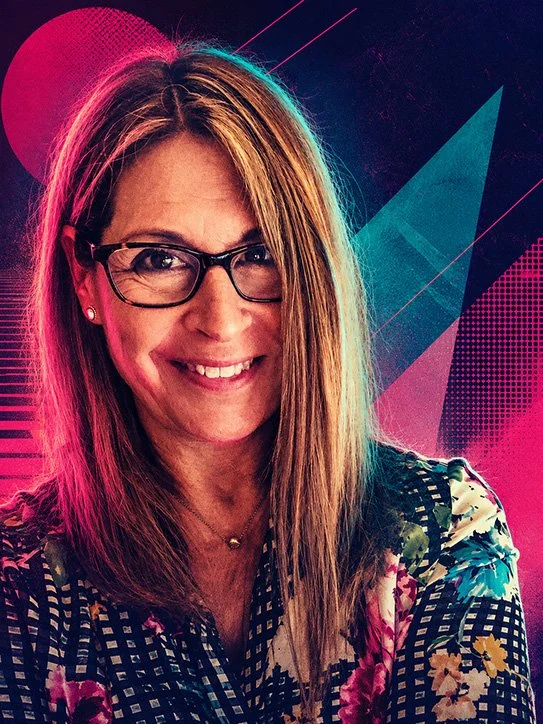 A woman with glasses smiling against a colorful, abstract digital background.