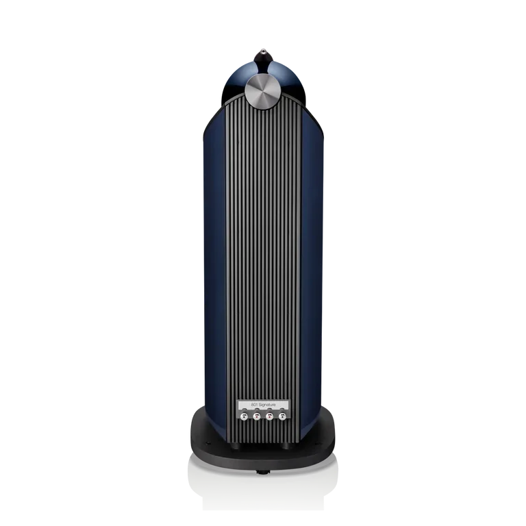A tall, modern speaker with a dark blue and black design, featuring vertical fin-like structures, a circular control knob at the top, and a label reading '801 Signature' near the bottom.