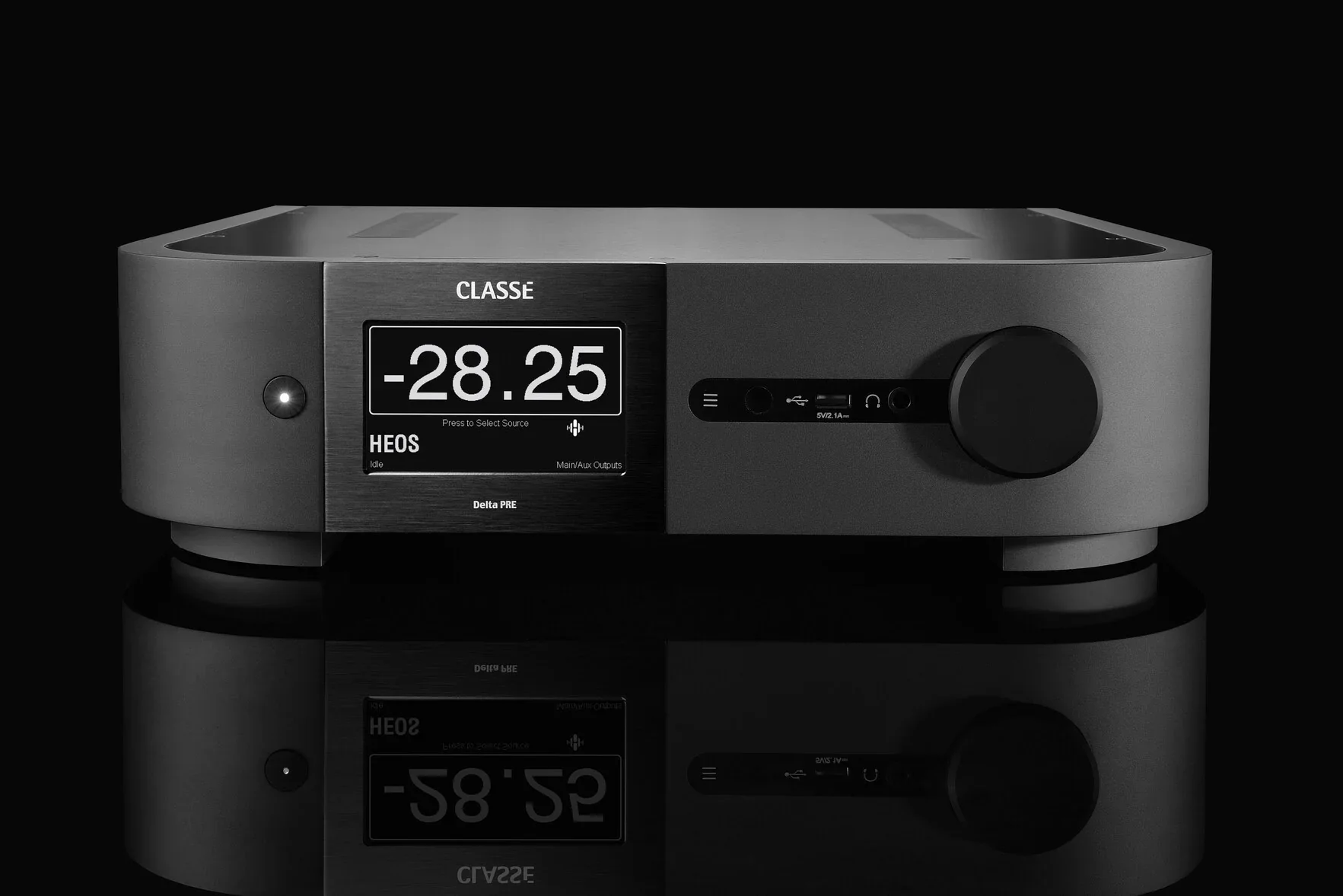 A sleek, modern audio device with a large digital display showing -28.25, labeled 'Classe HEOS', with various connection ports and a large knob on a reflective black surface.