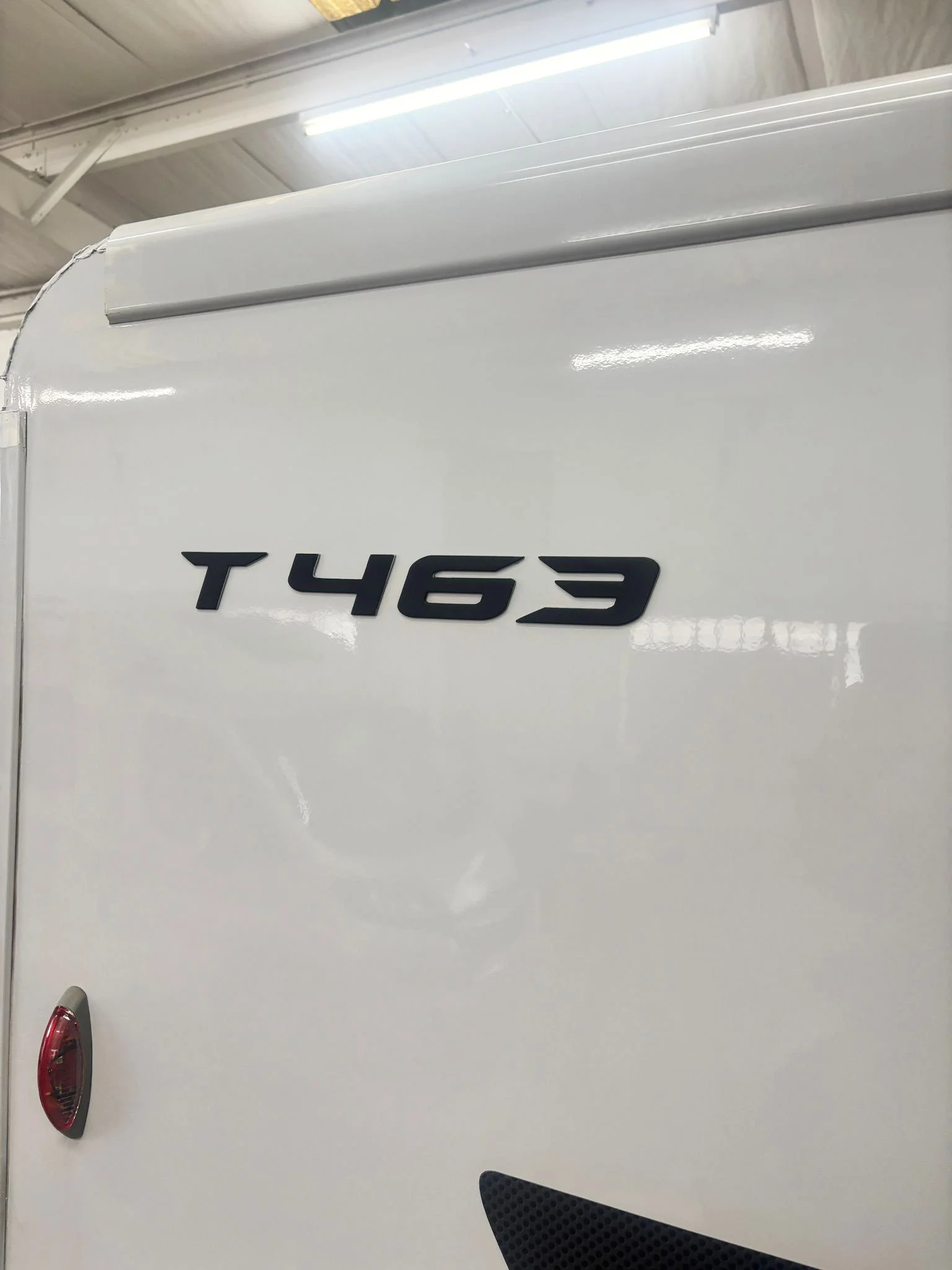 Close-up of the side of a white motorhome after a completed SMART repair.