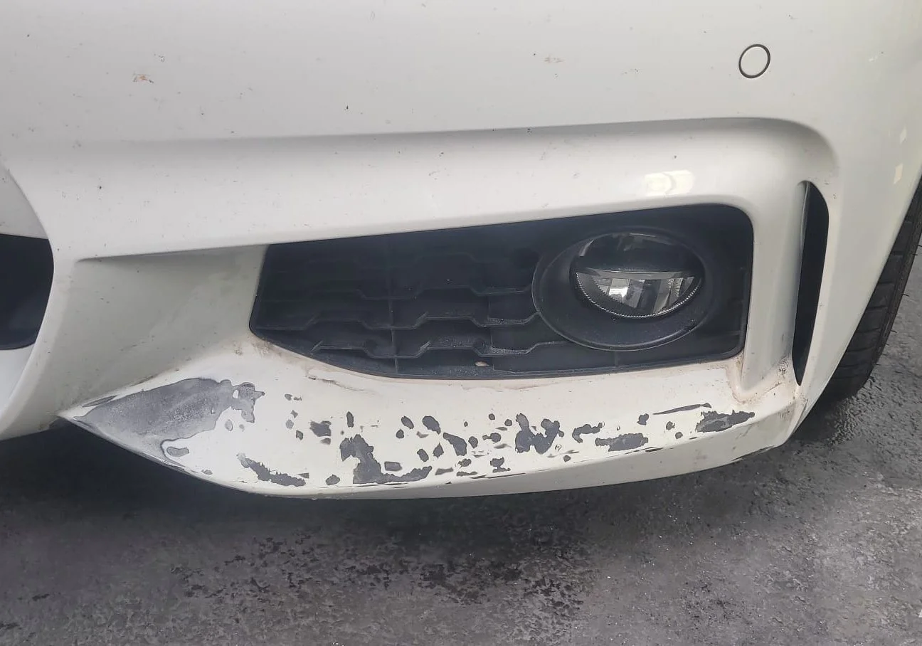 white car with significant damage before an onsite cosmetic smart repair