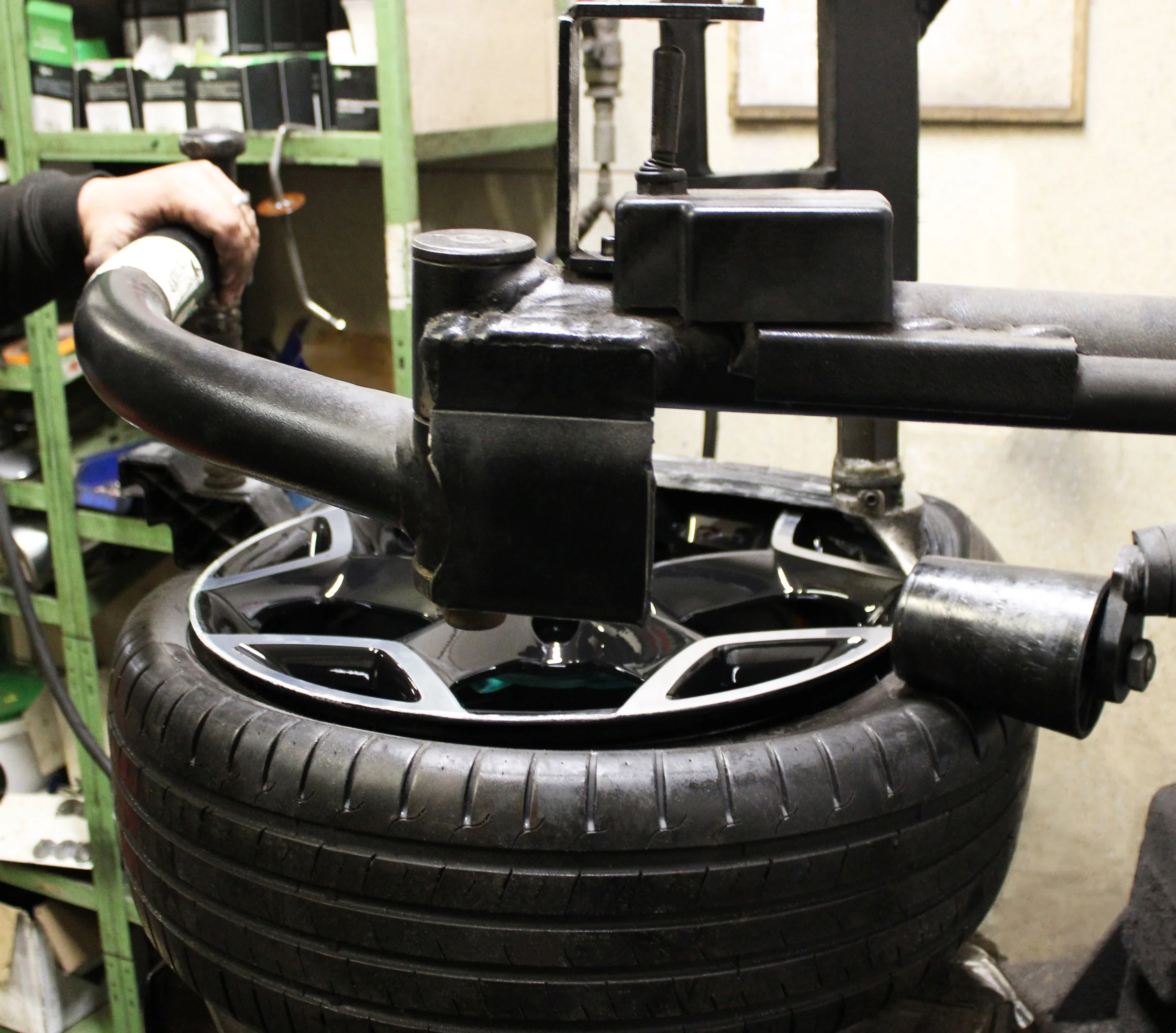 A diamond cut alloy freshly refurbished with the tyre being put back on using a tyre machine in RS Wheels workshop.