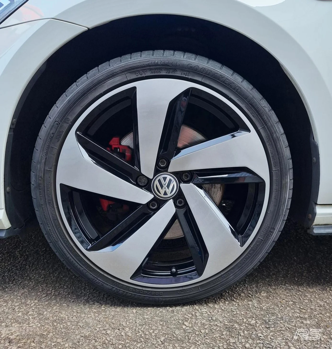 Close-up of a Volkswagen car wheel with a black and diamond cut finish.