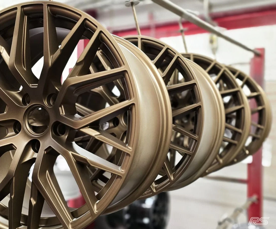 custom bronze alloy wheels hung up after being expertly powder coated