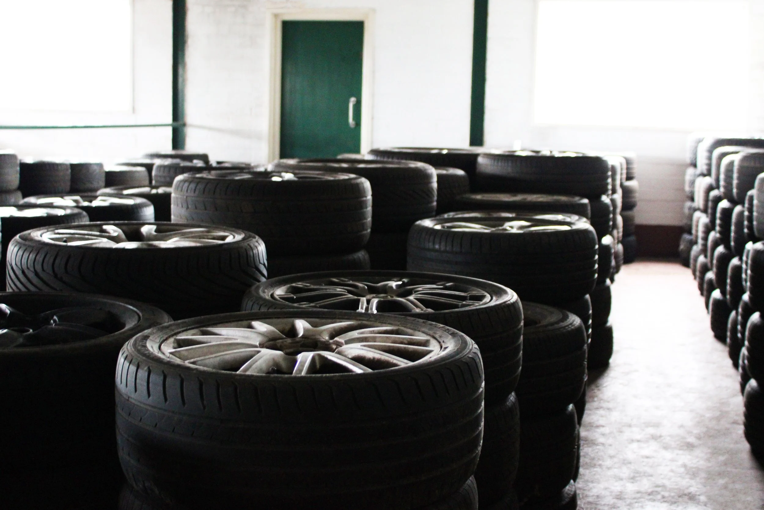 A room filled with stacked Loan Wheels arranged in rows in the RS Wheels workshop.
