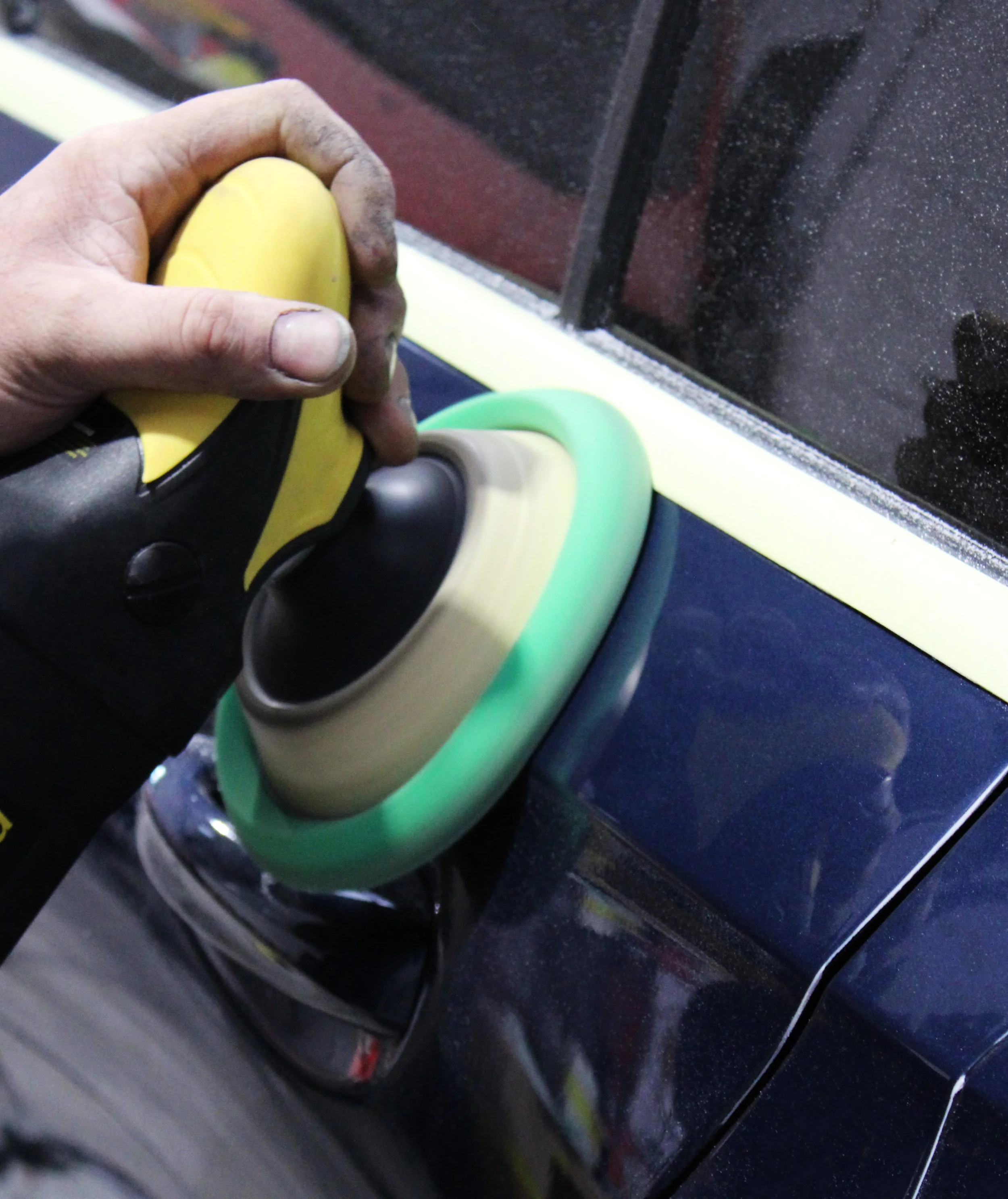 RS Wheels technician polishing a vehicle