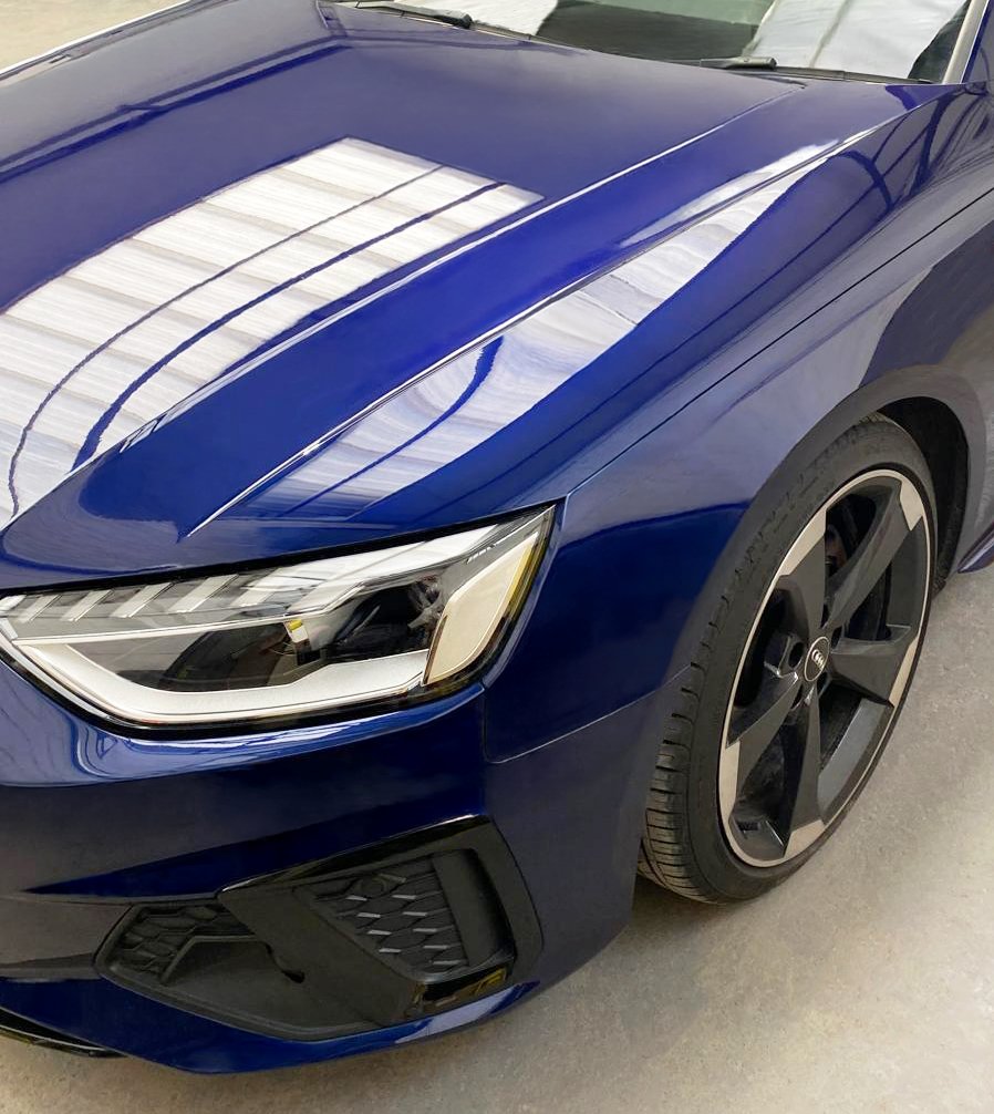 A close up of a blue vehicle with a shiny paint finish after being repaired by RS Wheels bodyshop