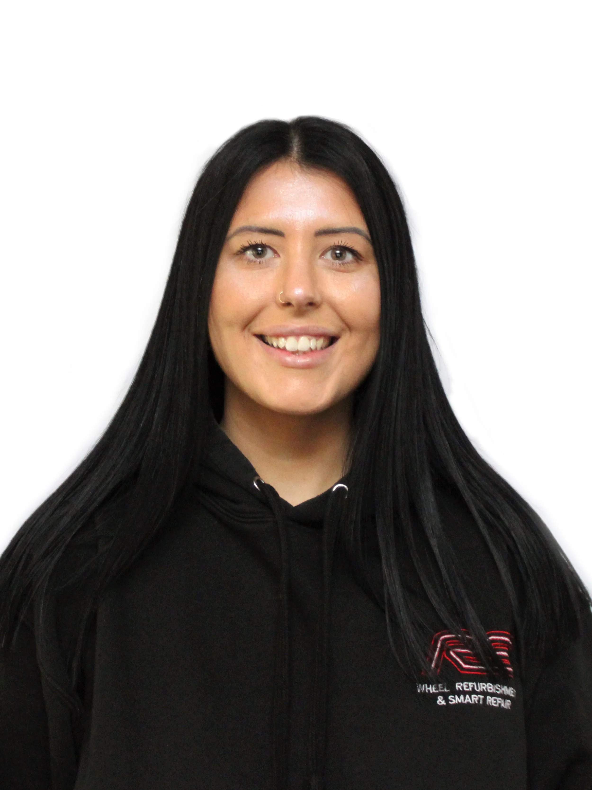 A woman with long black hair, fair skin, and a friendly smile, wearing a black hoodie with a logo that reads 'Wheel Refurbish & Smart Repair.'