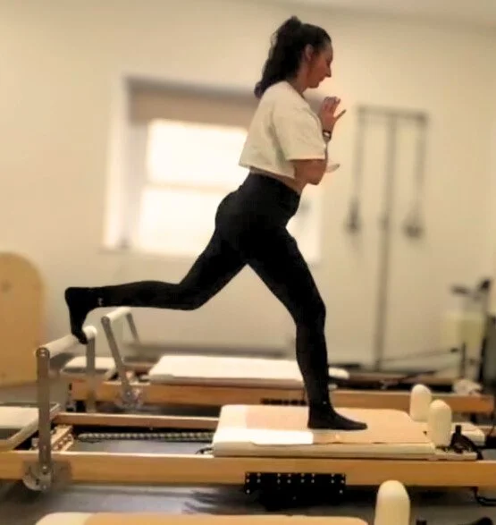 Pilates Reformer lunge at Studio Di Rosa in Shankill, Dublin, demonstrating strength, balance and controlled movement with expert guidance.