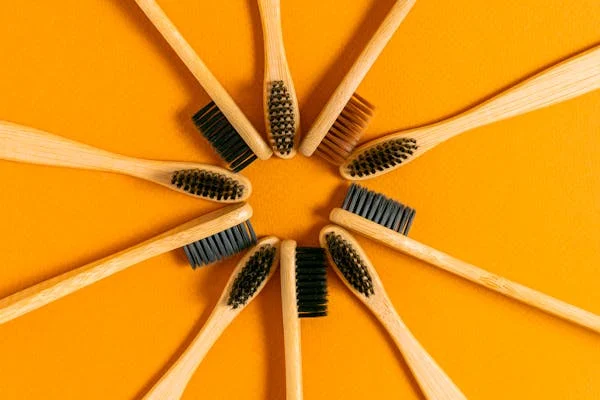 Wooden toothbrushes against orange background