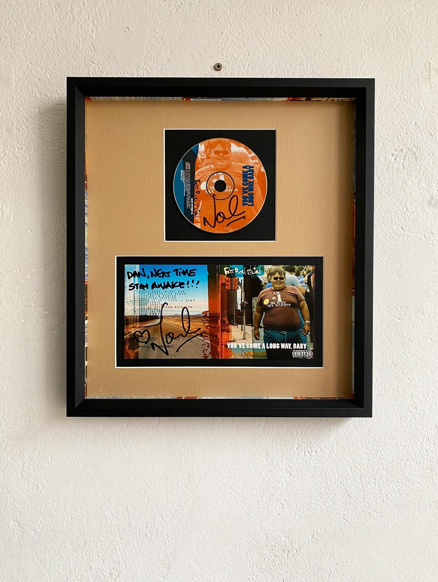 Some of the finest music memorabilia dismantled and reassembled to give it the praise it deserves!

Everything about this piece is so punchy! from the warm orangey mount to the smooth Matte black bevelled frame.

Individual mount windows sat over bla