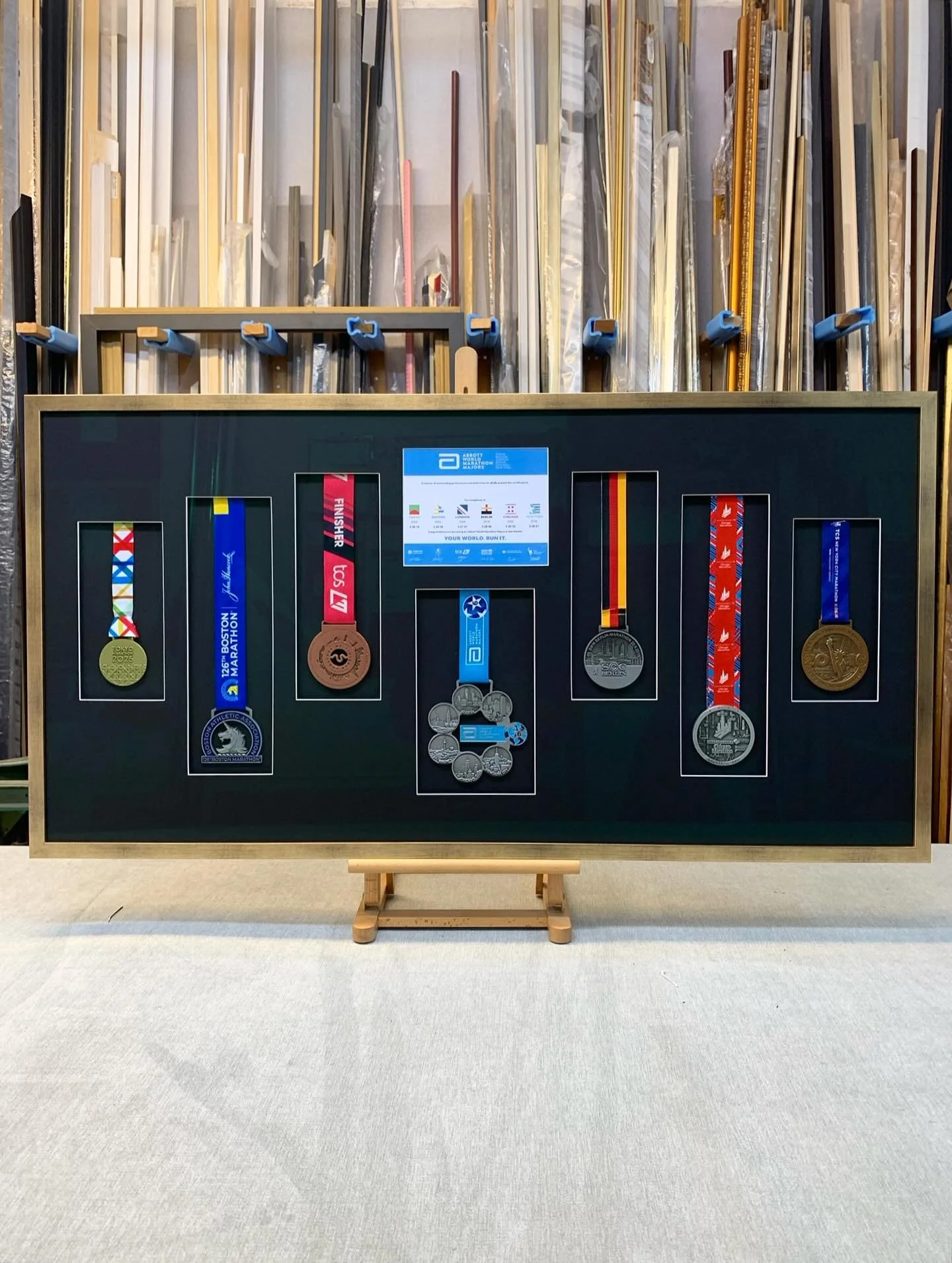 A showcase of achievements for an unbelievable runner out there!
A display of medals from the abbots major marathon collection, super impressive I know!
These medals are all nestled beautifully into a bespoke hand cut display of windows, on a black m