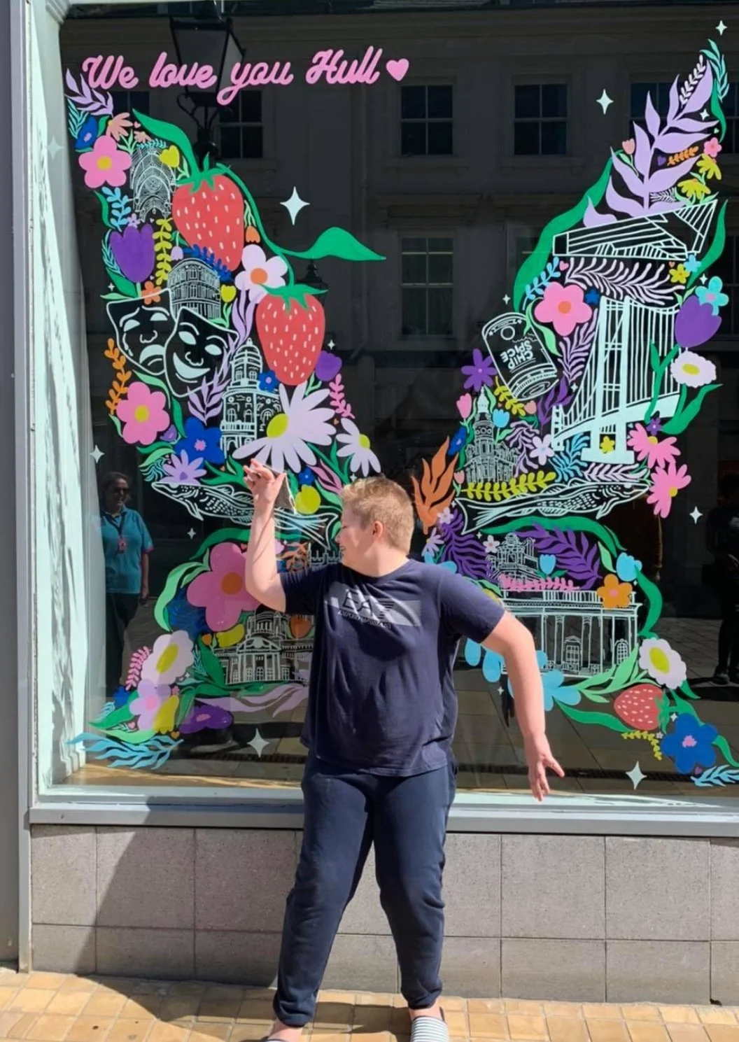 Person in front of colourful window